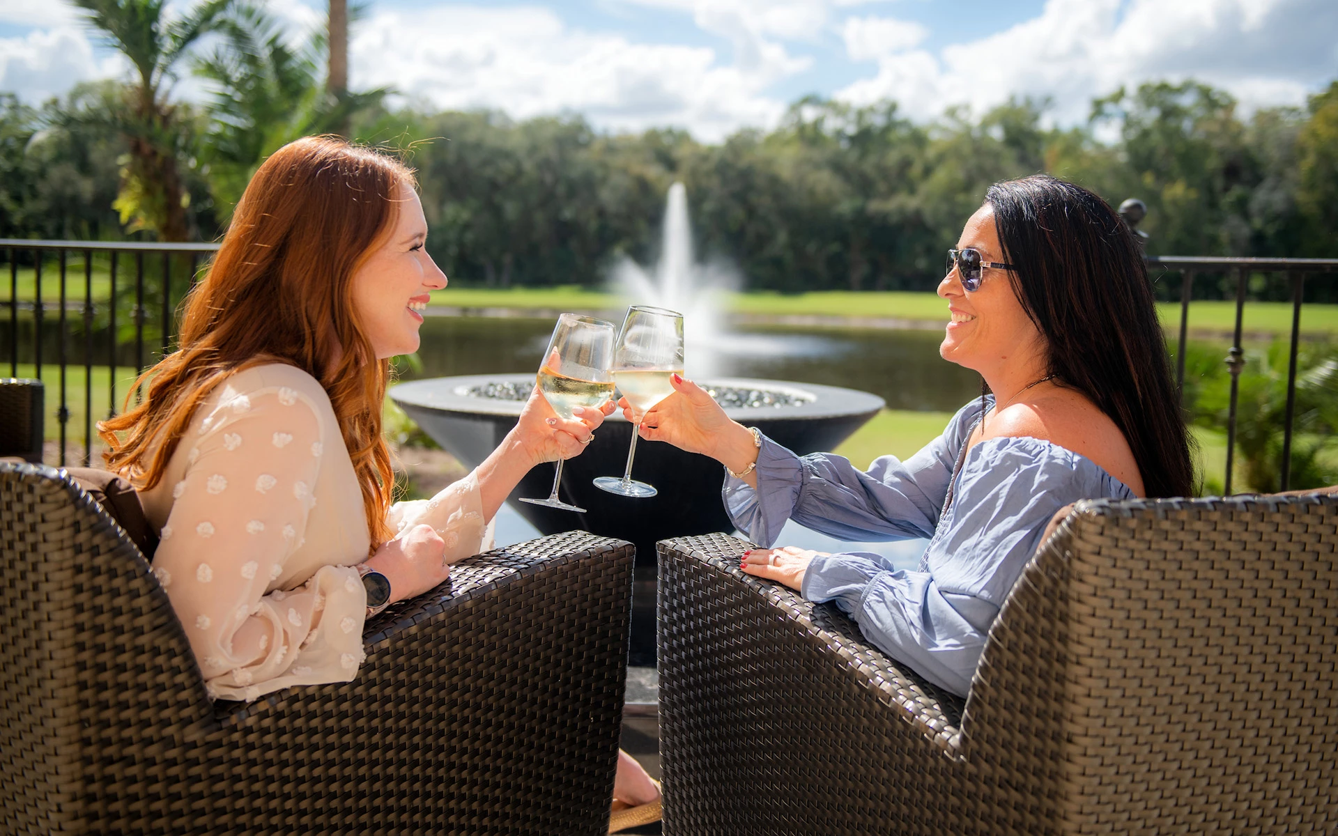 female members laughing over a glass of wine at Ardea