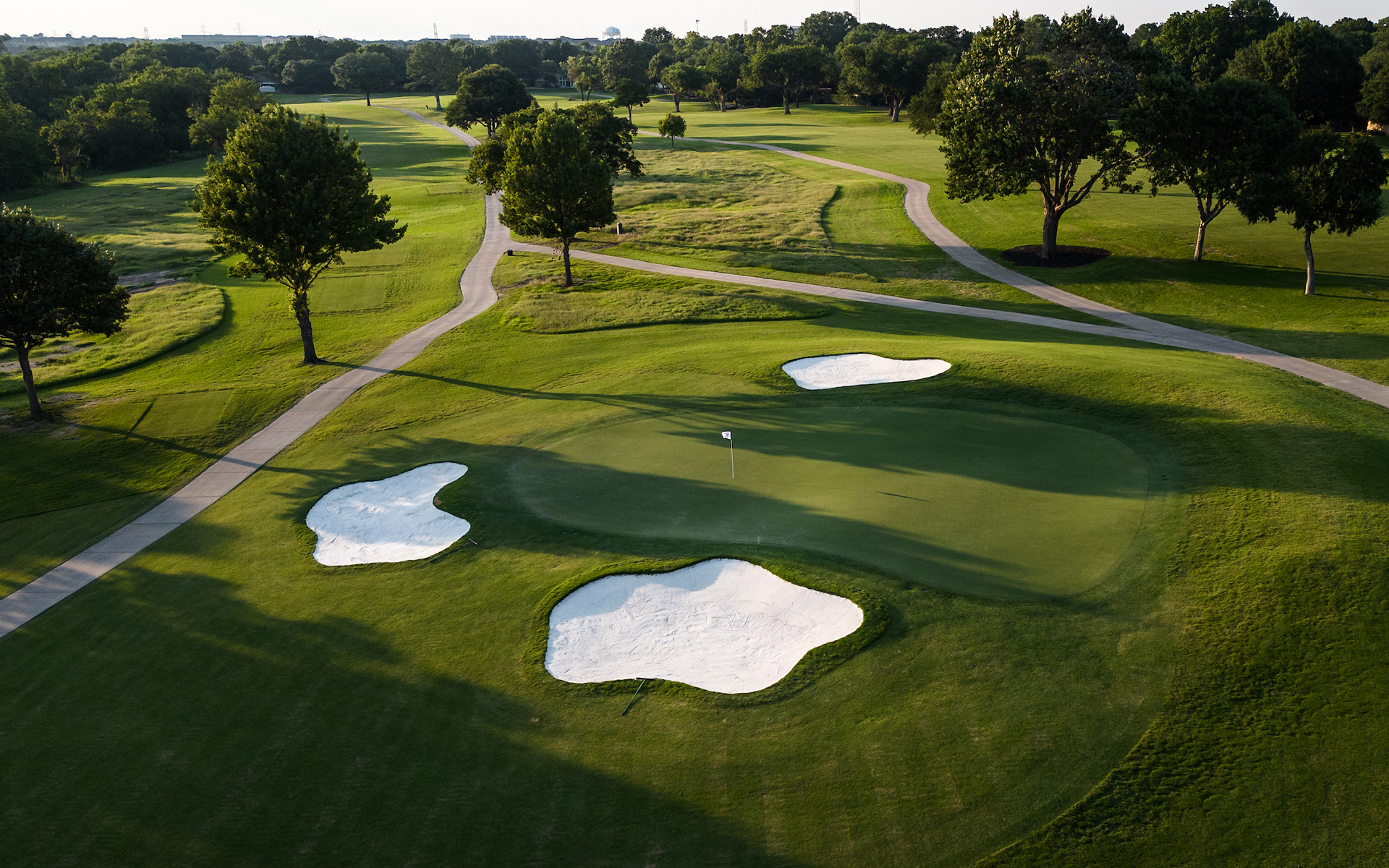 Canyon Creek fairway with tree-lined hole and creek