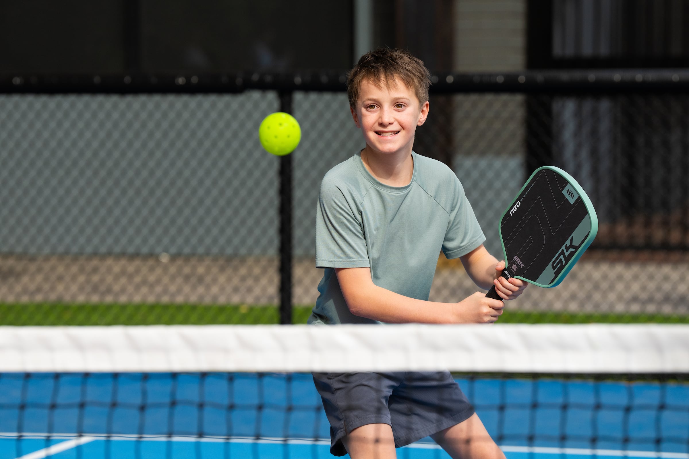 Child playing pickleball