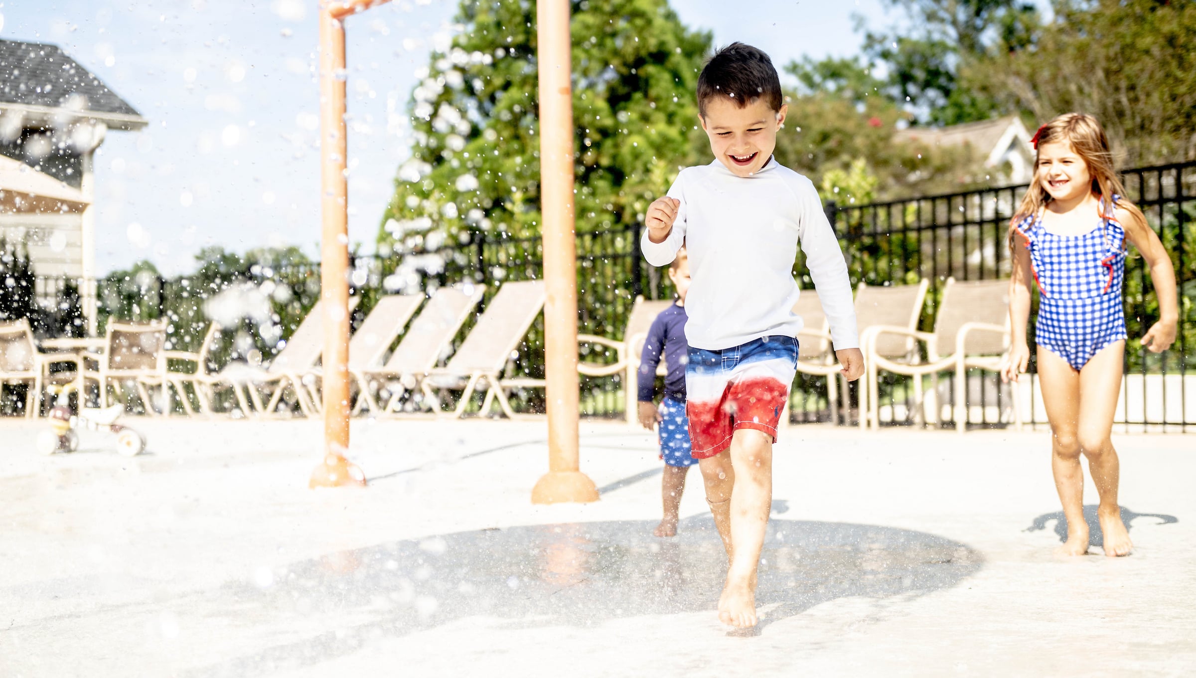 Children playing on a pool splash pad