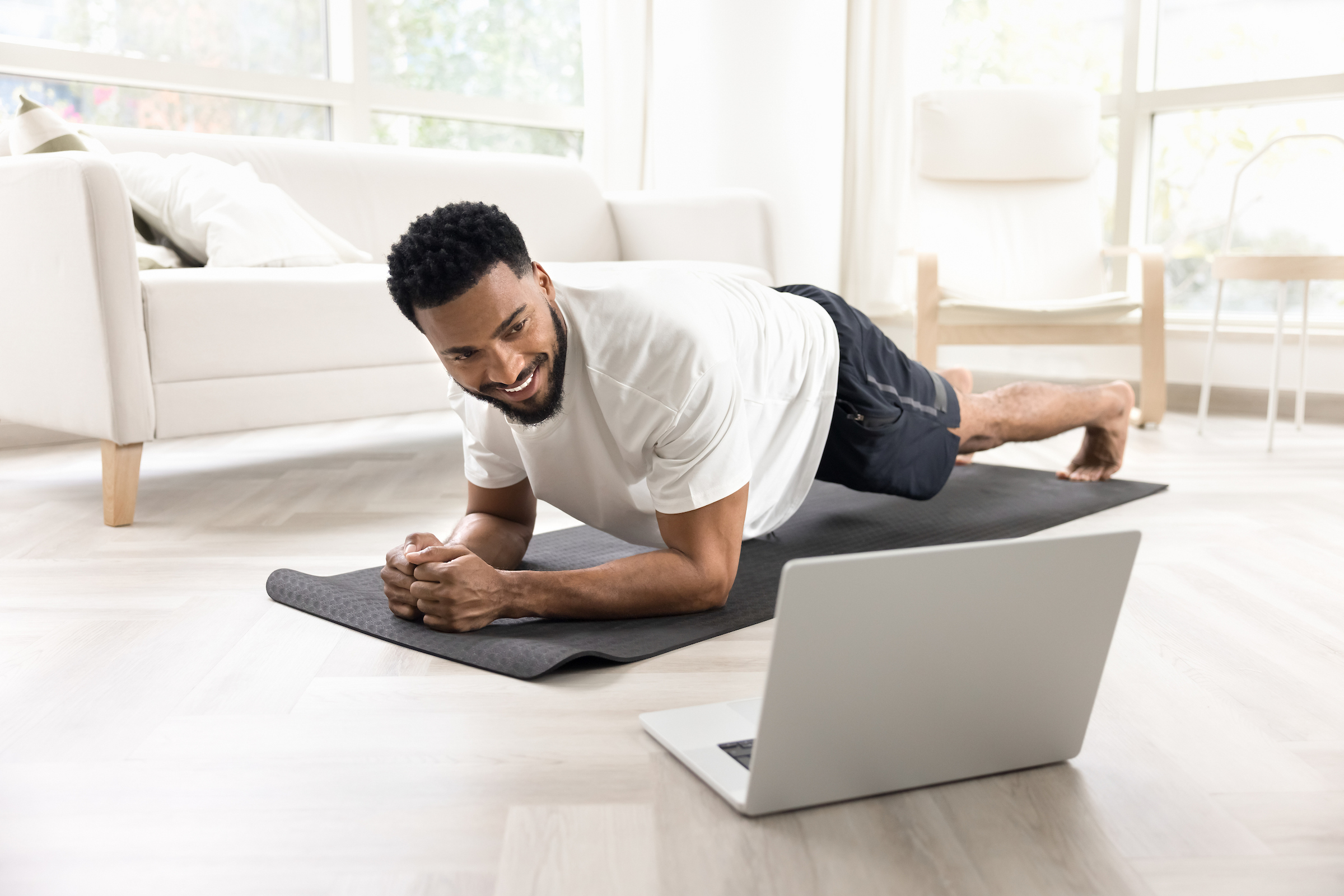 Young African American male enjoying a virtual fitness class