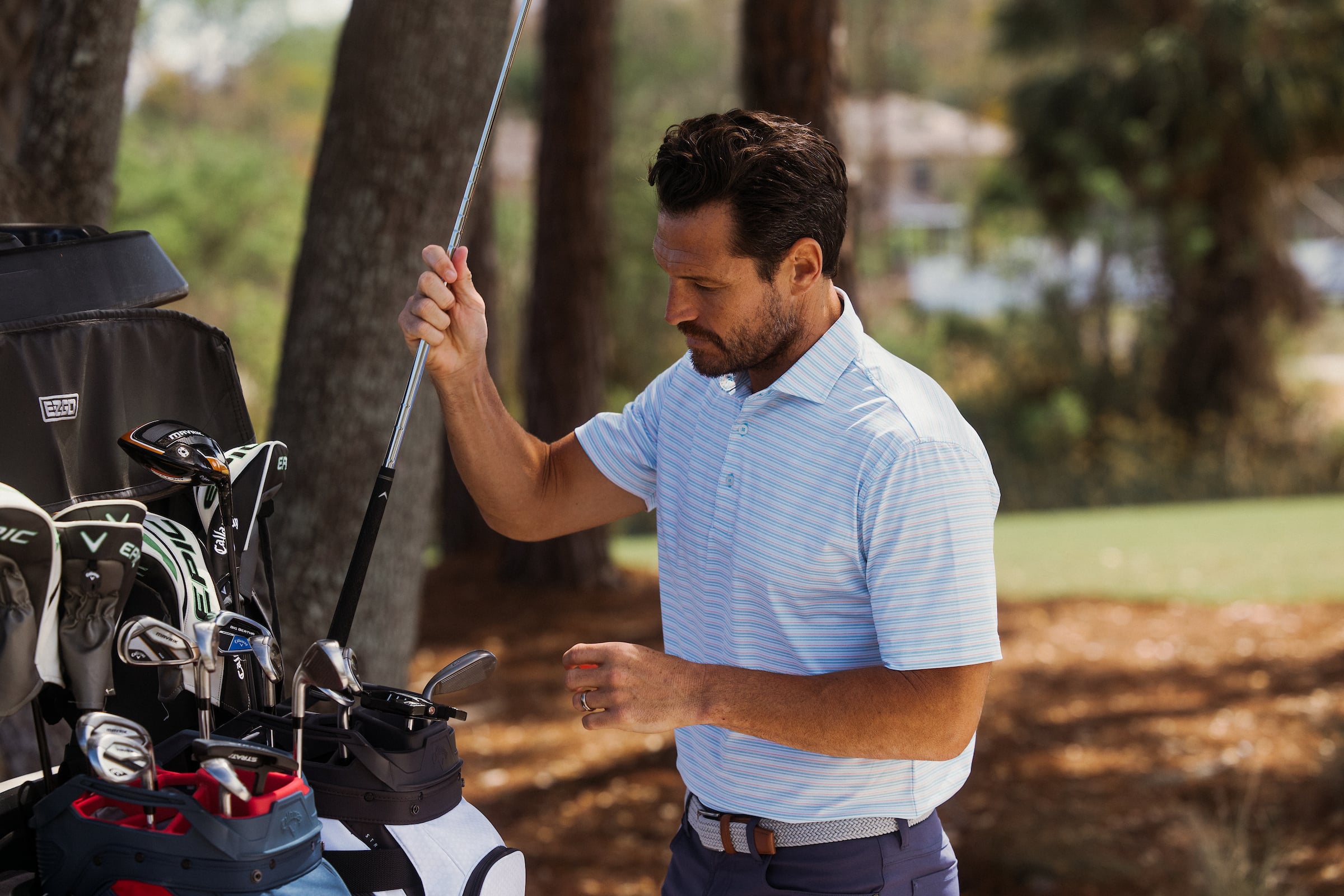 Golfer taking out a golf club from bag