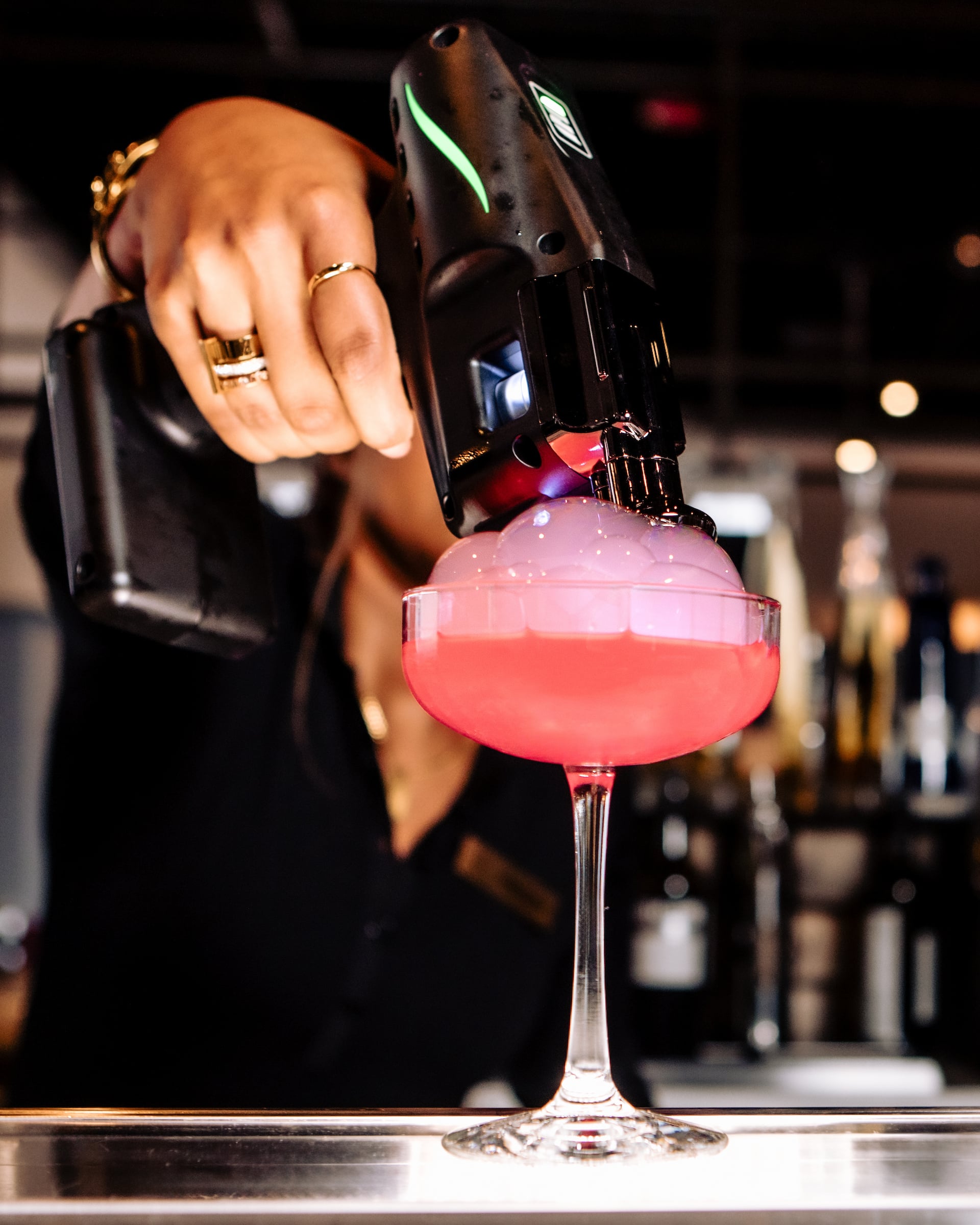 Drink being mixed on bar.