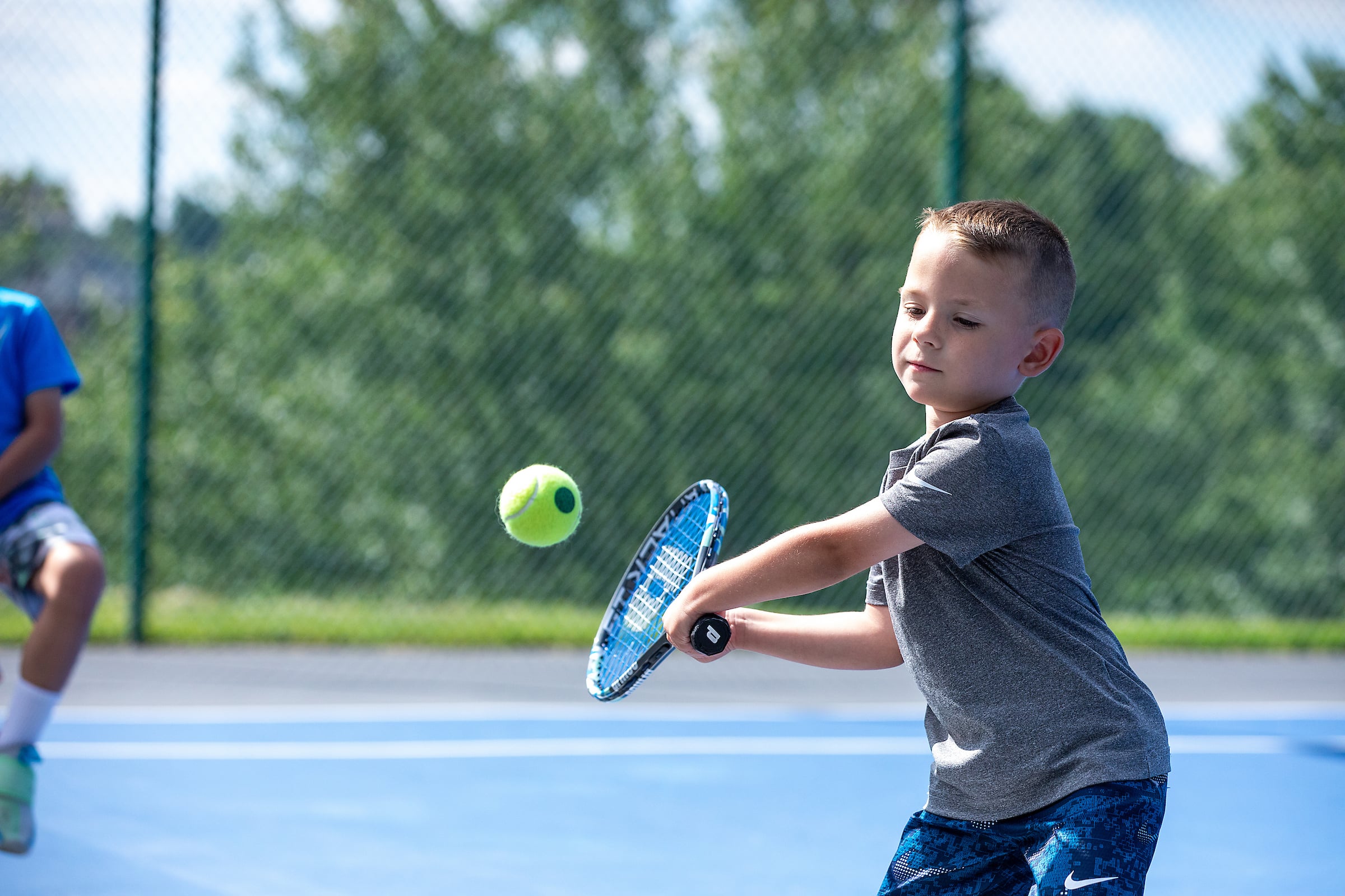 Child playing tennis