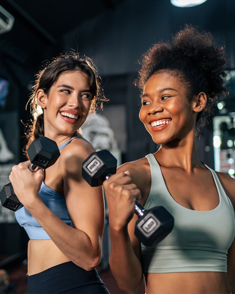 Two young females working out together and having fun