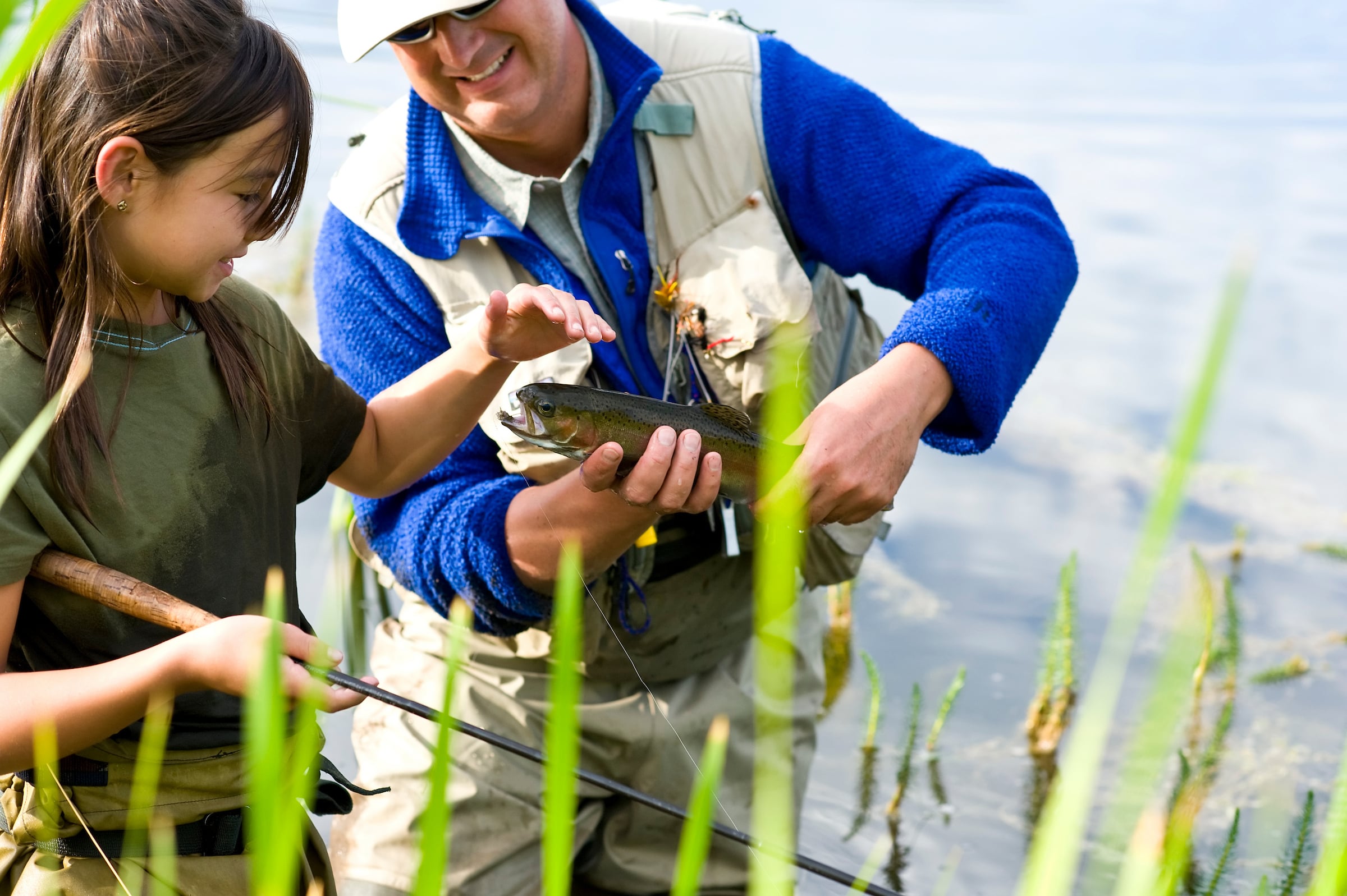 Girl & Man holding a fish