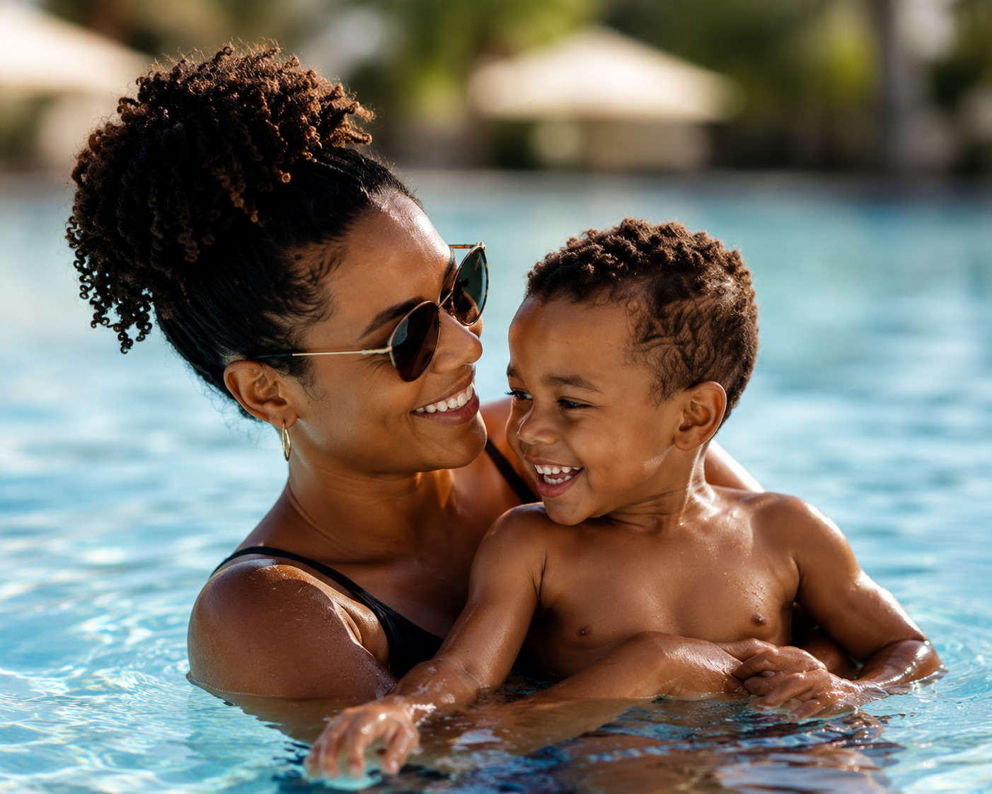 African American mom and son swimming in the pool