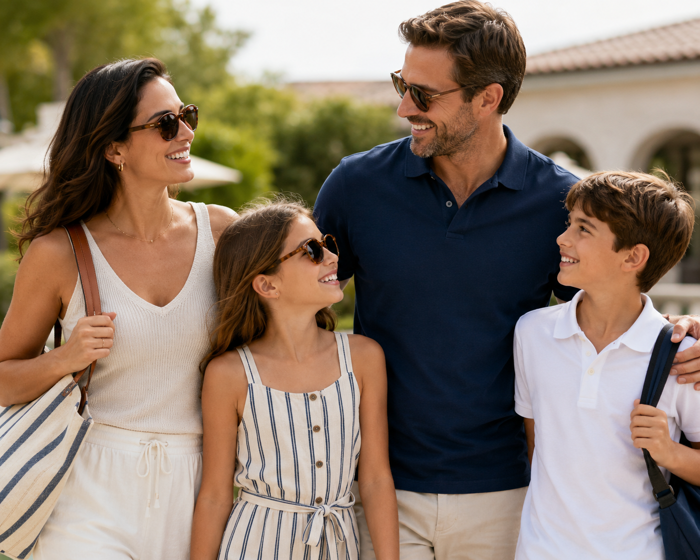 Young family of 4 walking to the pool