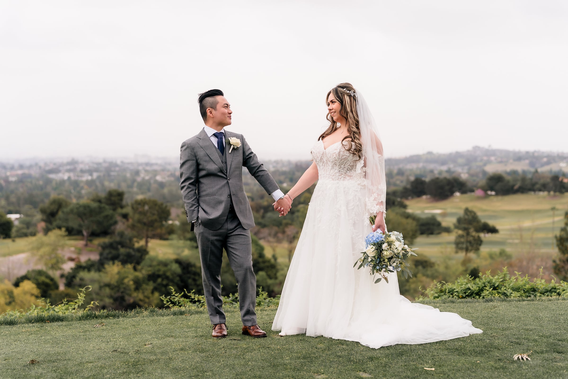 bride and groom standing on a golf course