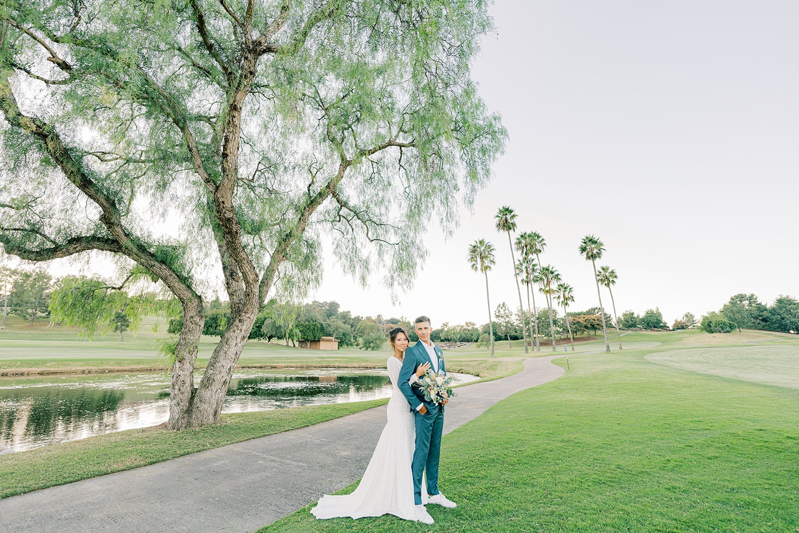 Bride & Groom posing for picture on golf course
