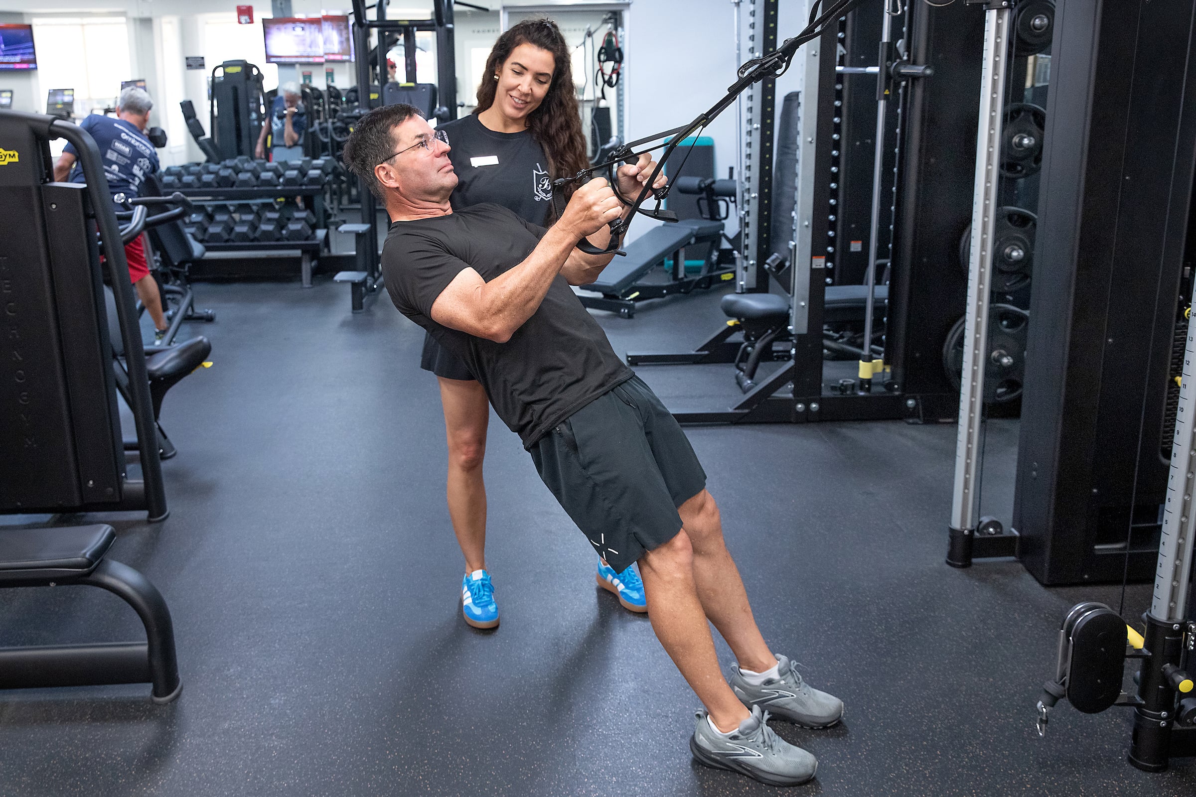 Man pulling rope in gym