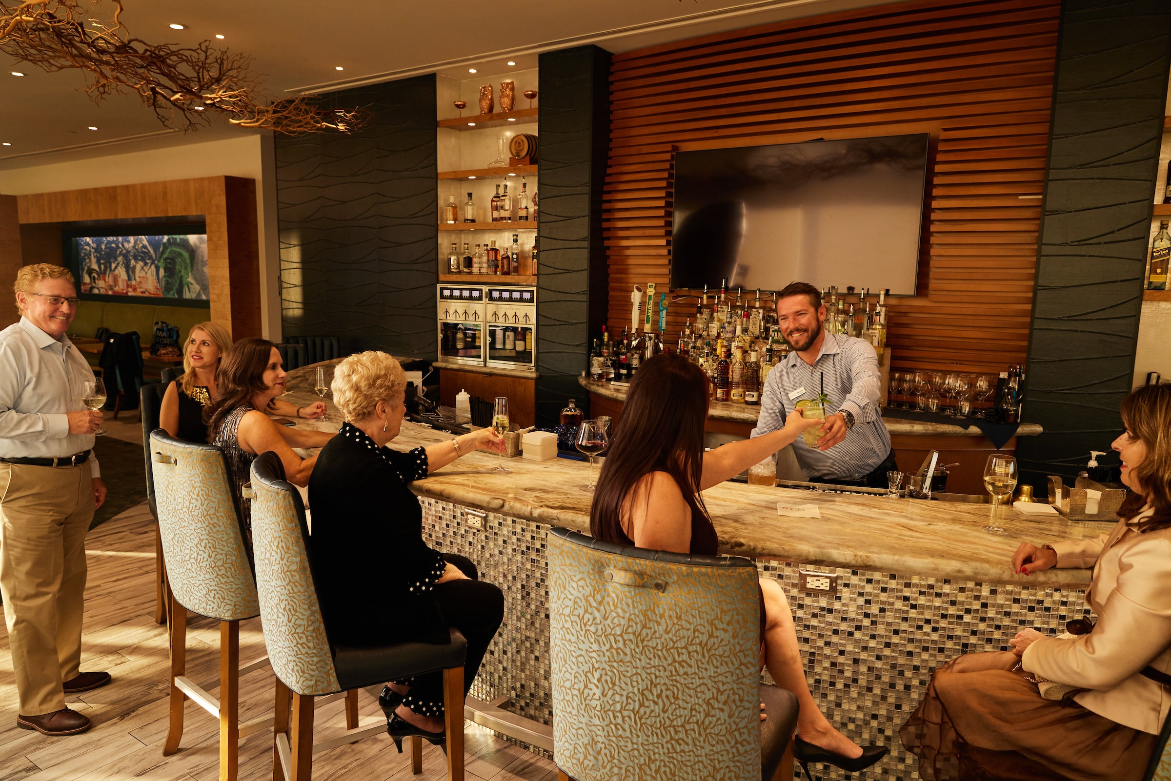 Men & Women in the Centre Club Tampa bar with the bartender serving a drink