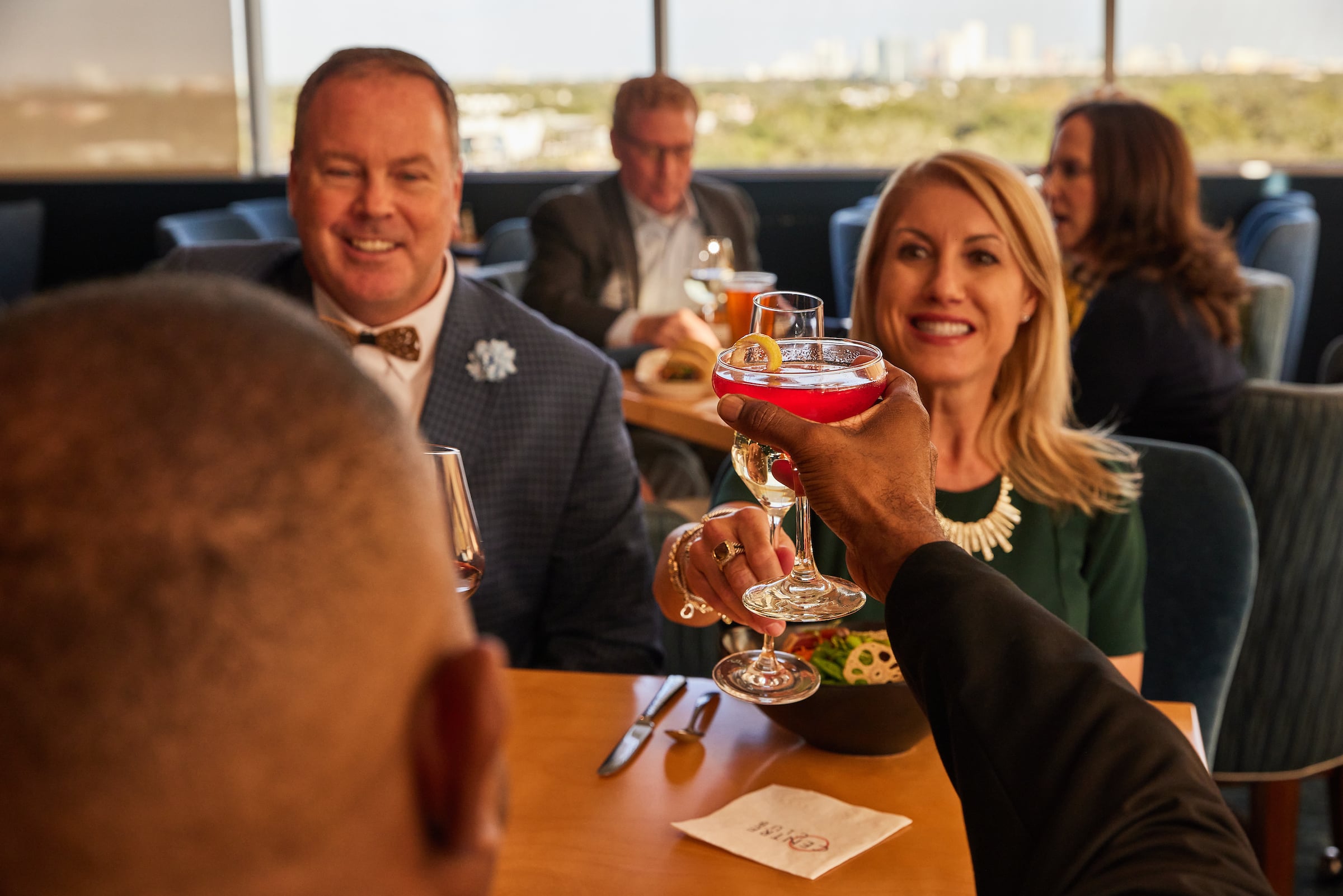 Men & Women toasting with drinks
