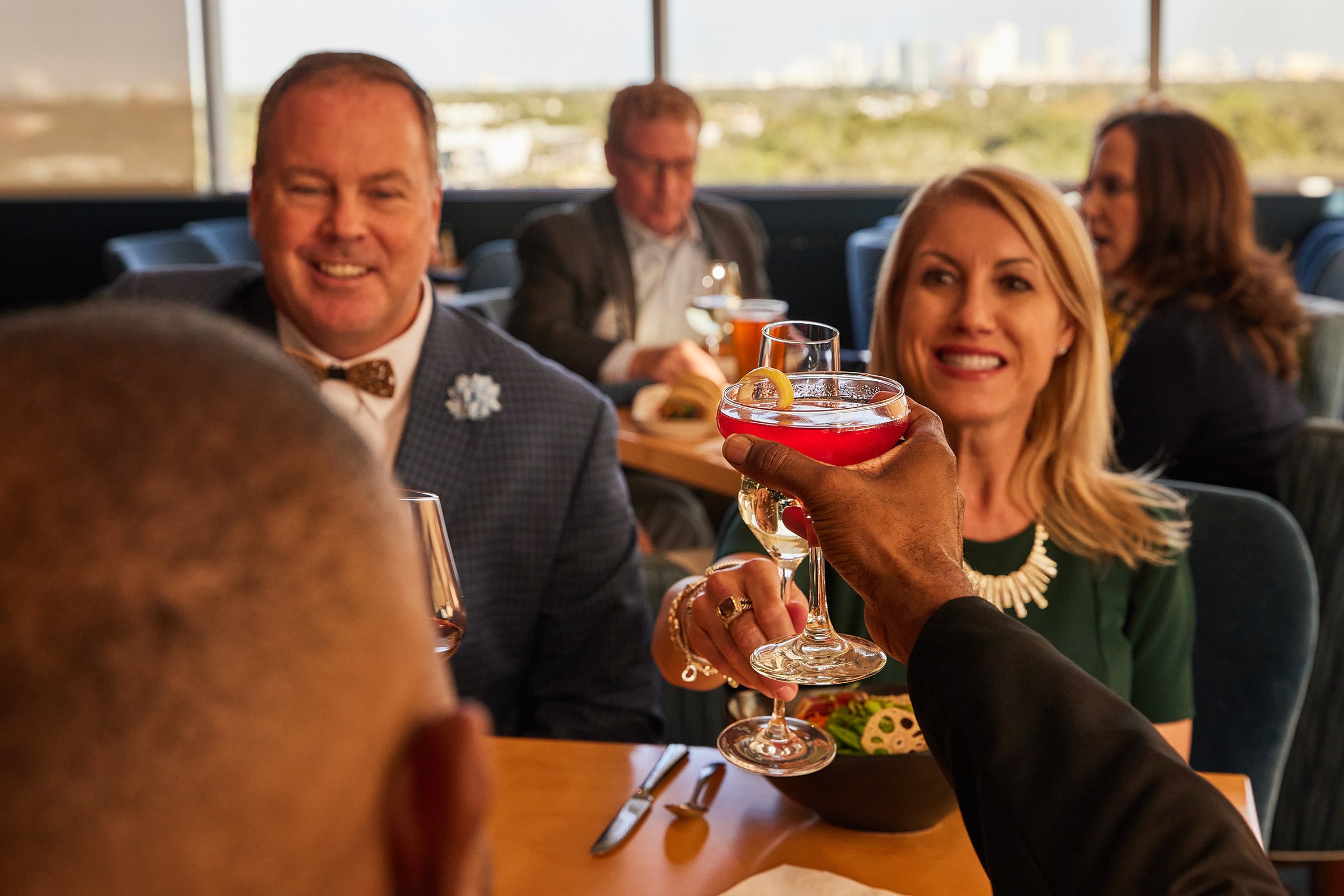 Men & Women toasting with drinks