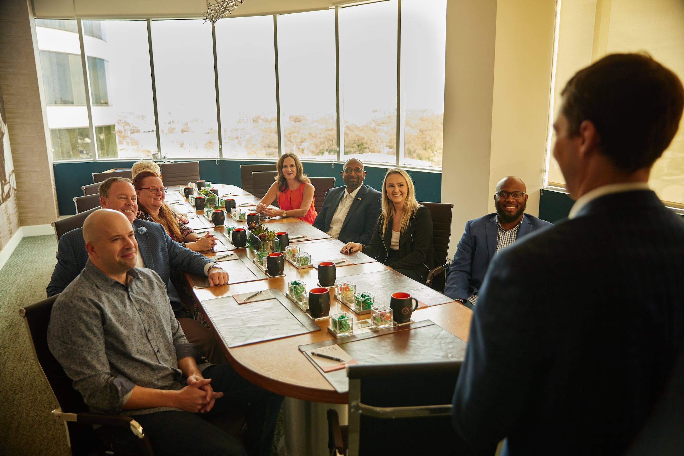 Group of people in a meeting around a oval table