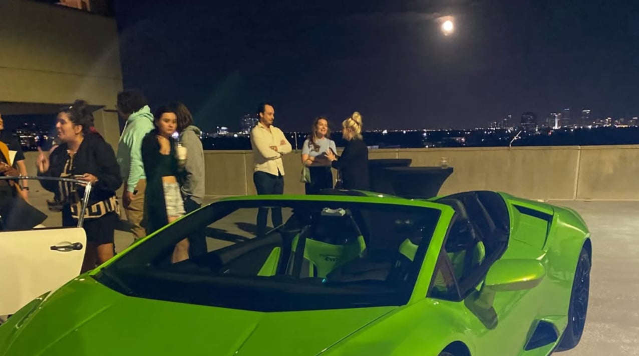 Men & Women standing outside by a neon green sportscar