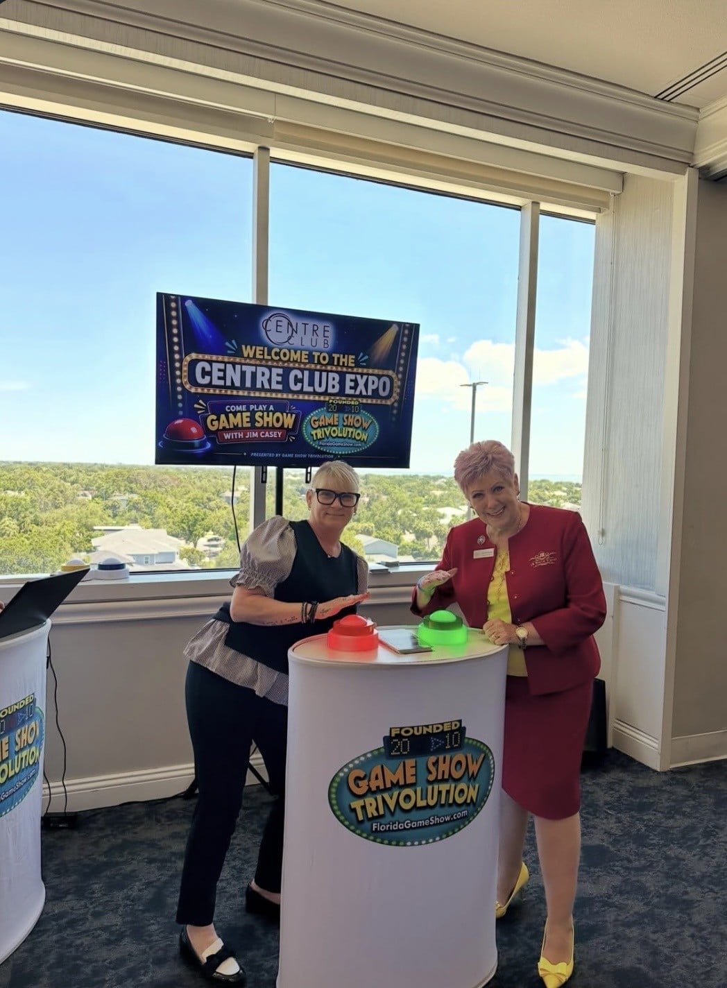 Two women standing by a podium