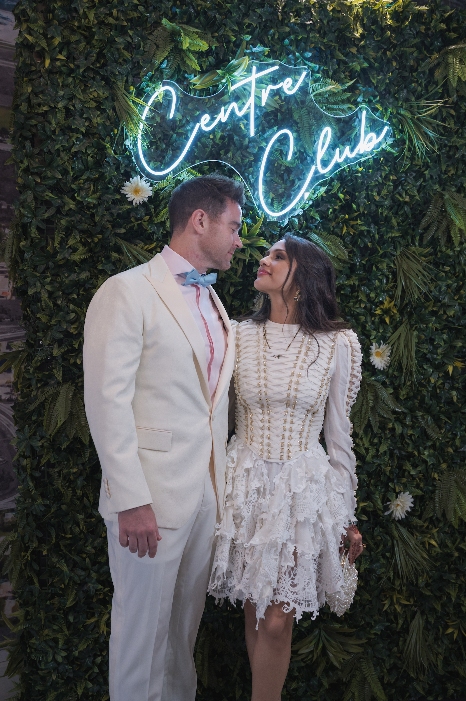 Man & Woman standing beneath the Centre Club Tampa sign at a private event
