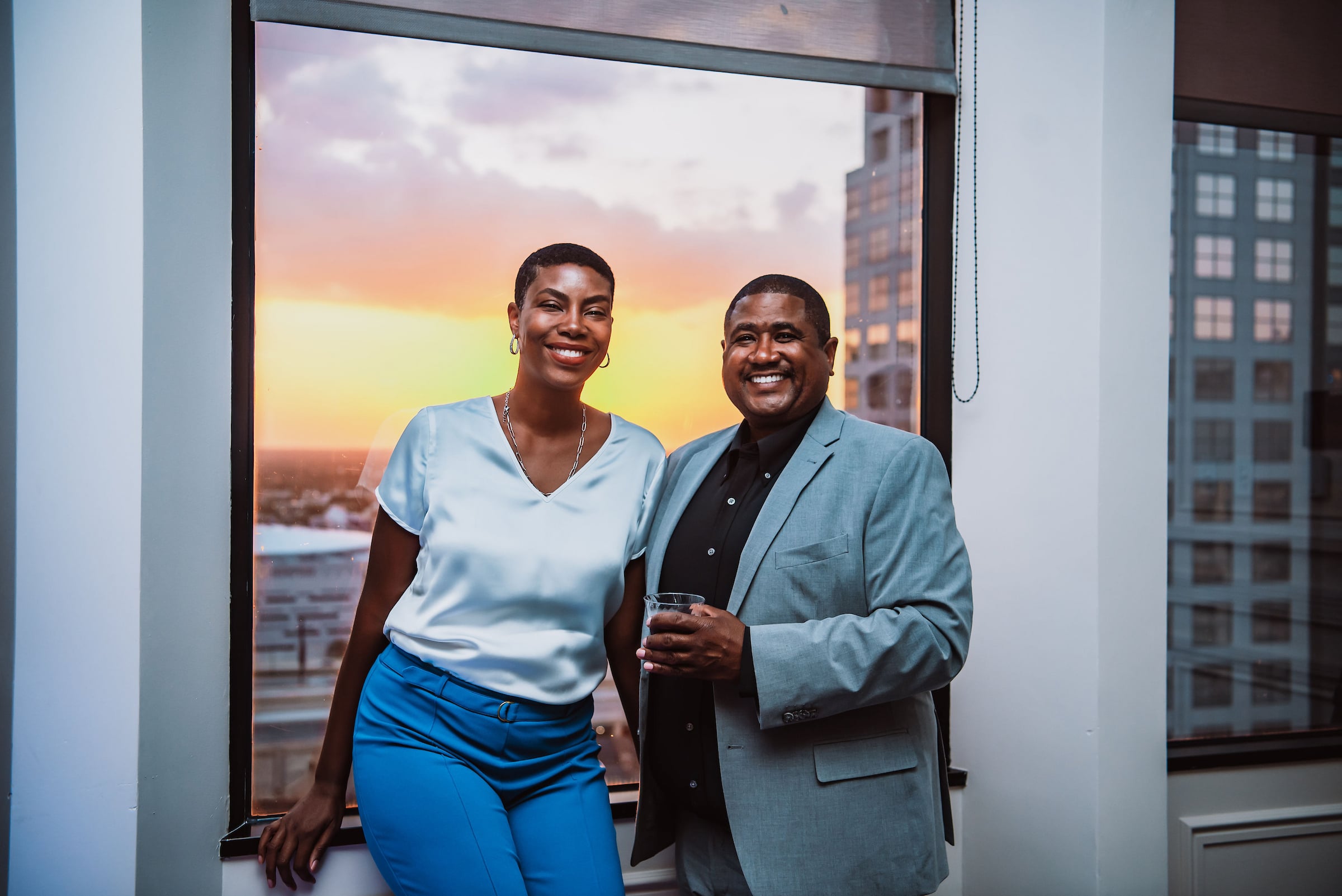Couple posing in front of a window at Citrus Club