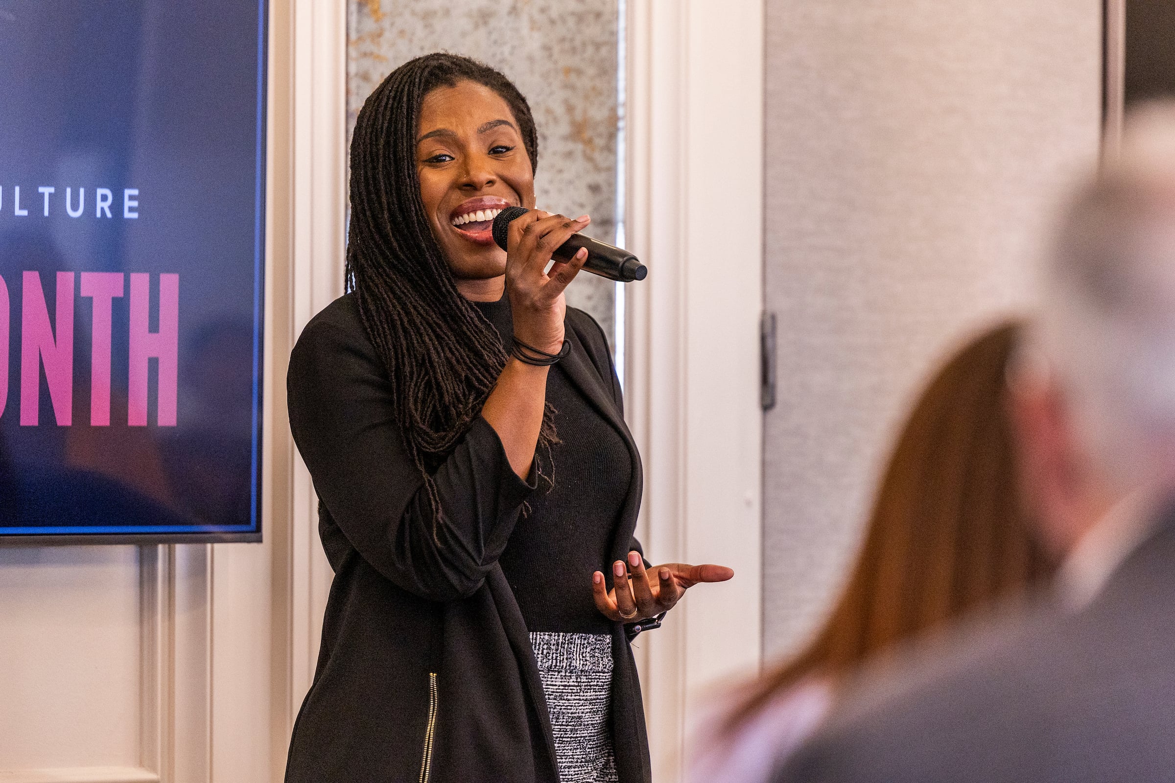 Woman speaking on a microphone
