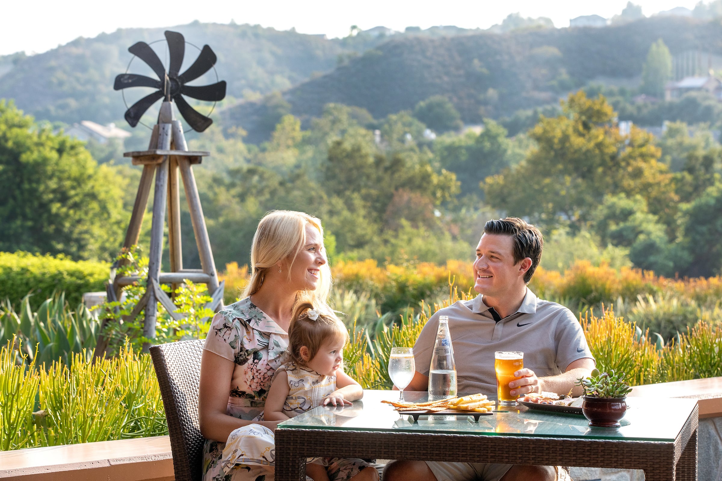 Woman, Man & child dining on patio
