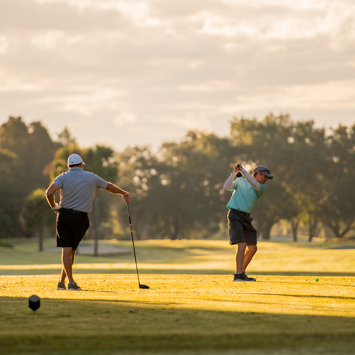 Man Playing golf at sunset