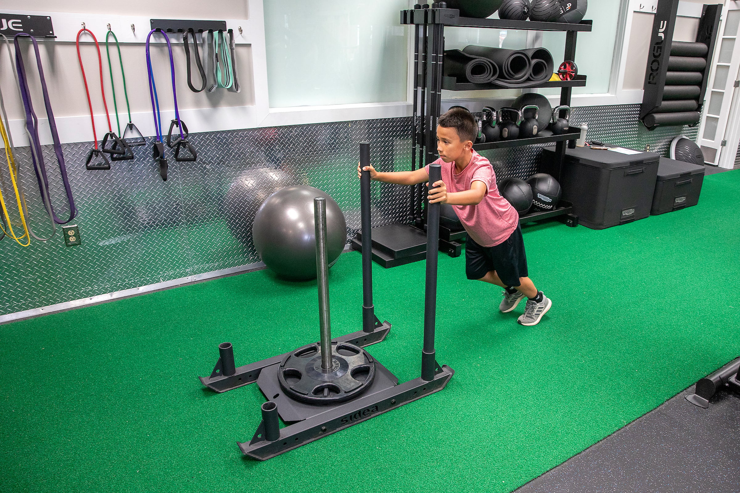 Young boy working out in the fitness center