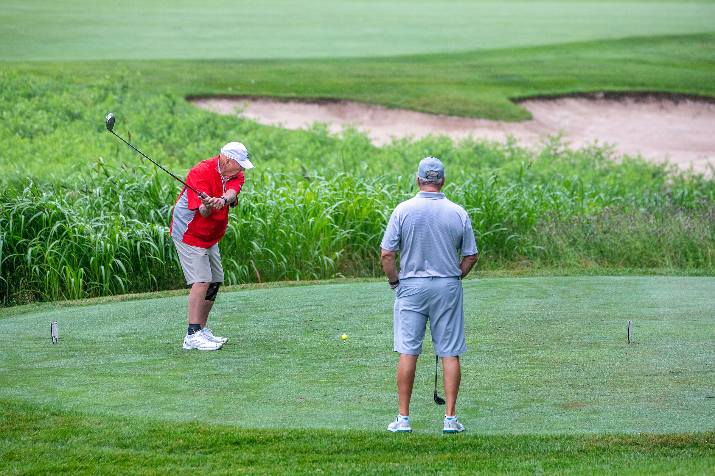 2 older men playing a round of golf