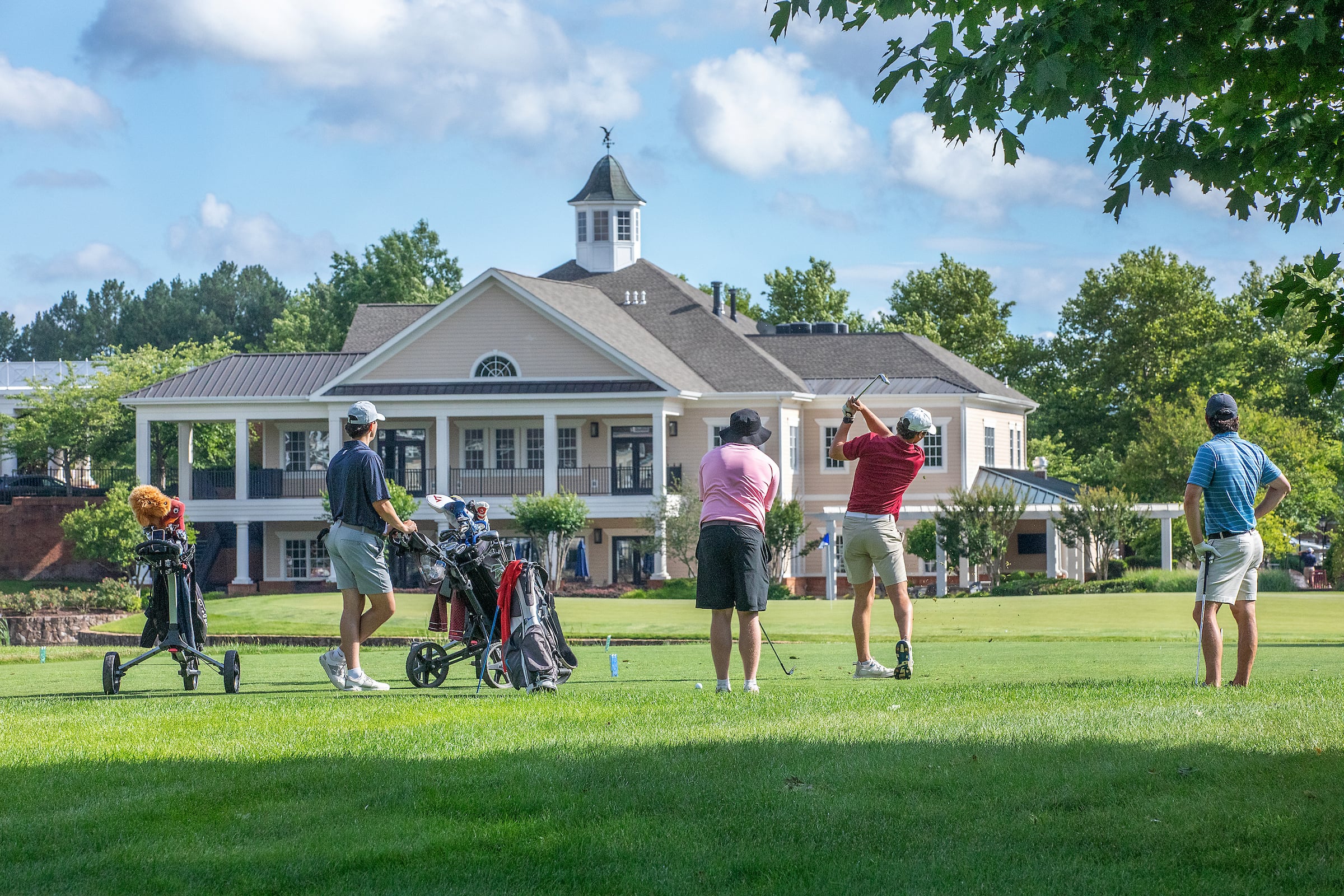 4 men playing a round of golf