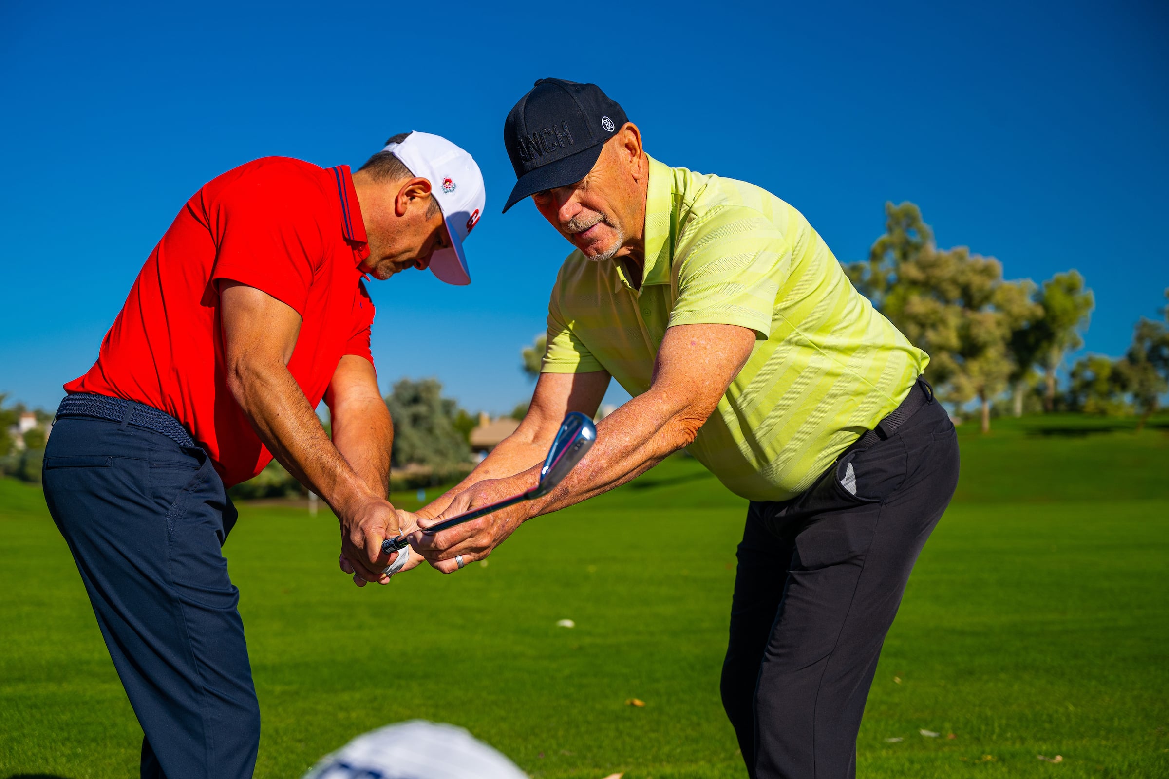 Man receiving a golf lesson