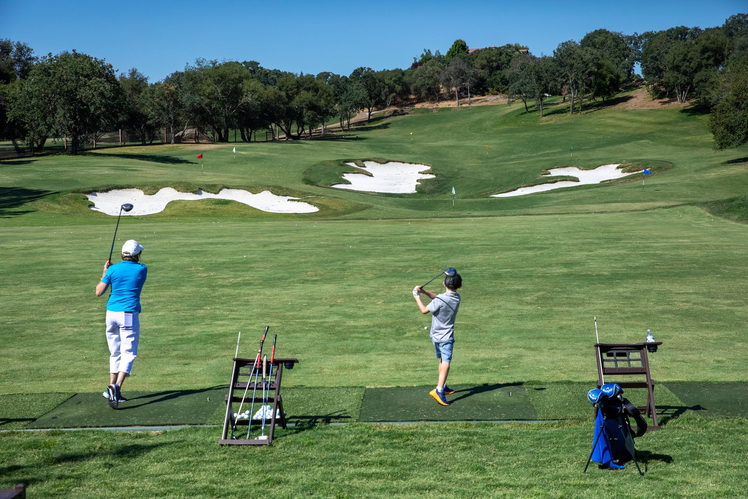 Mom and son practicing on the driving range