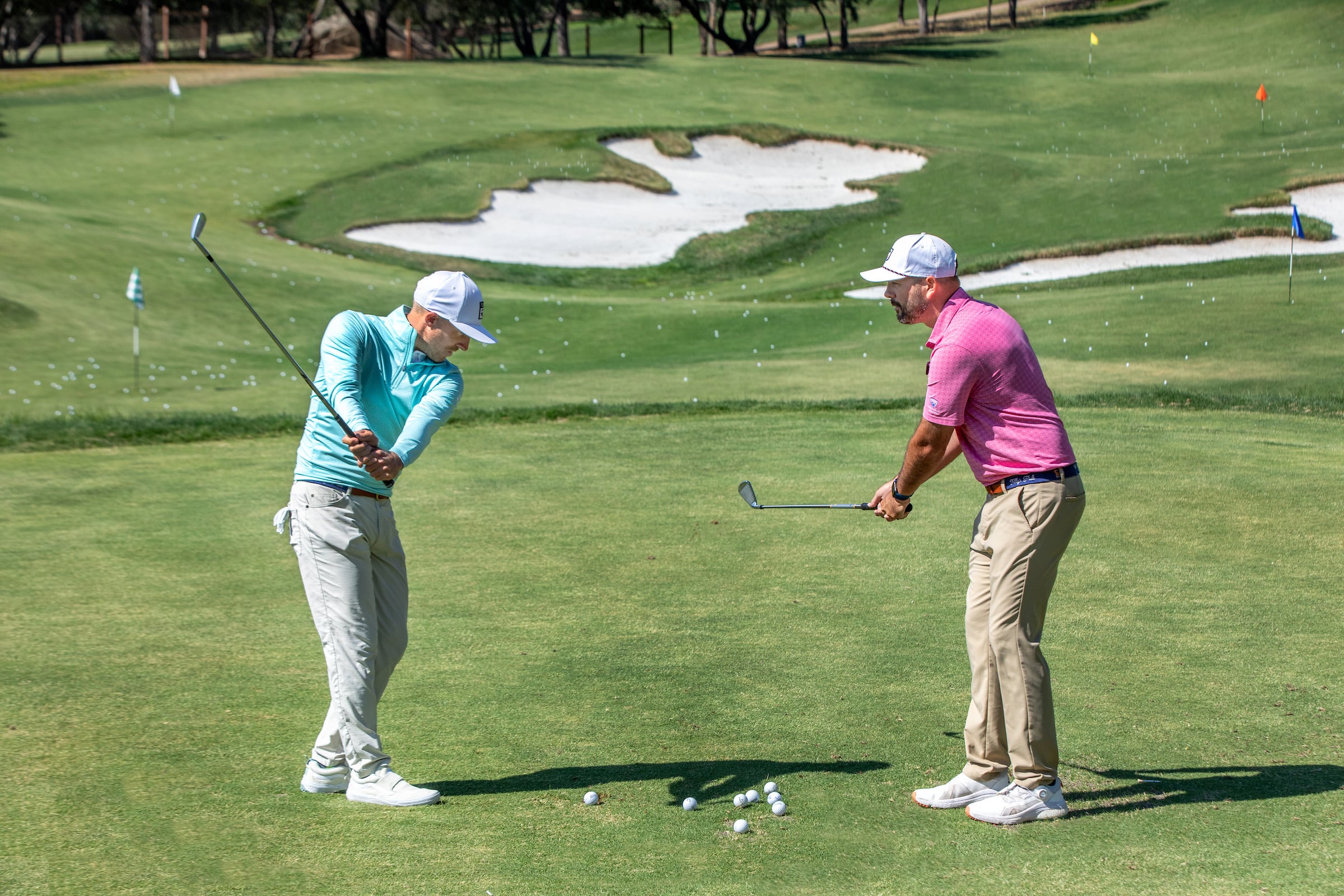 male golfer working a golf pro on his swing
