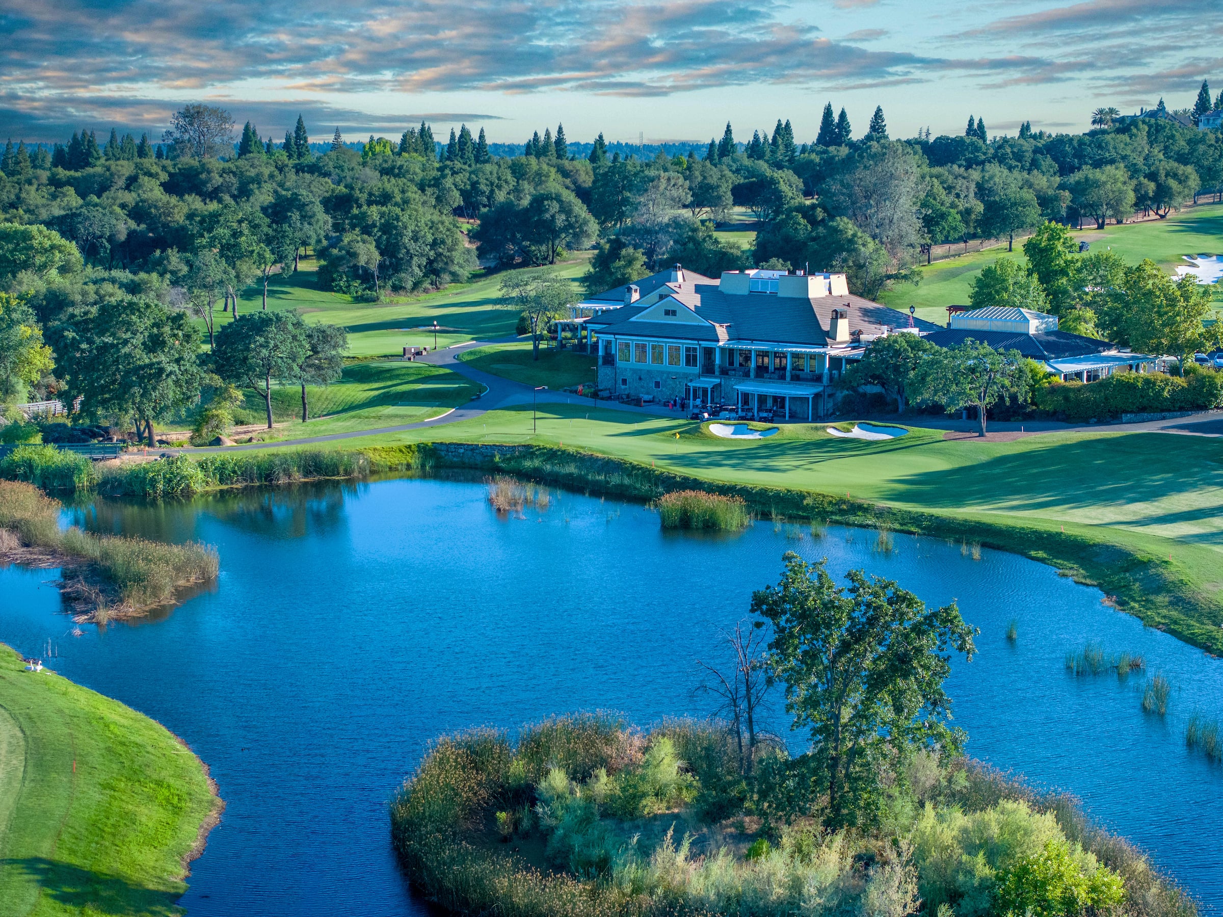 view of a clubhouse and a lake