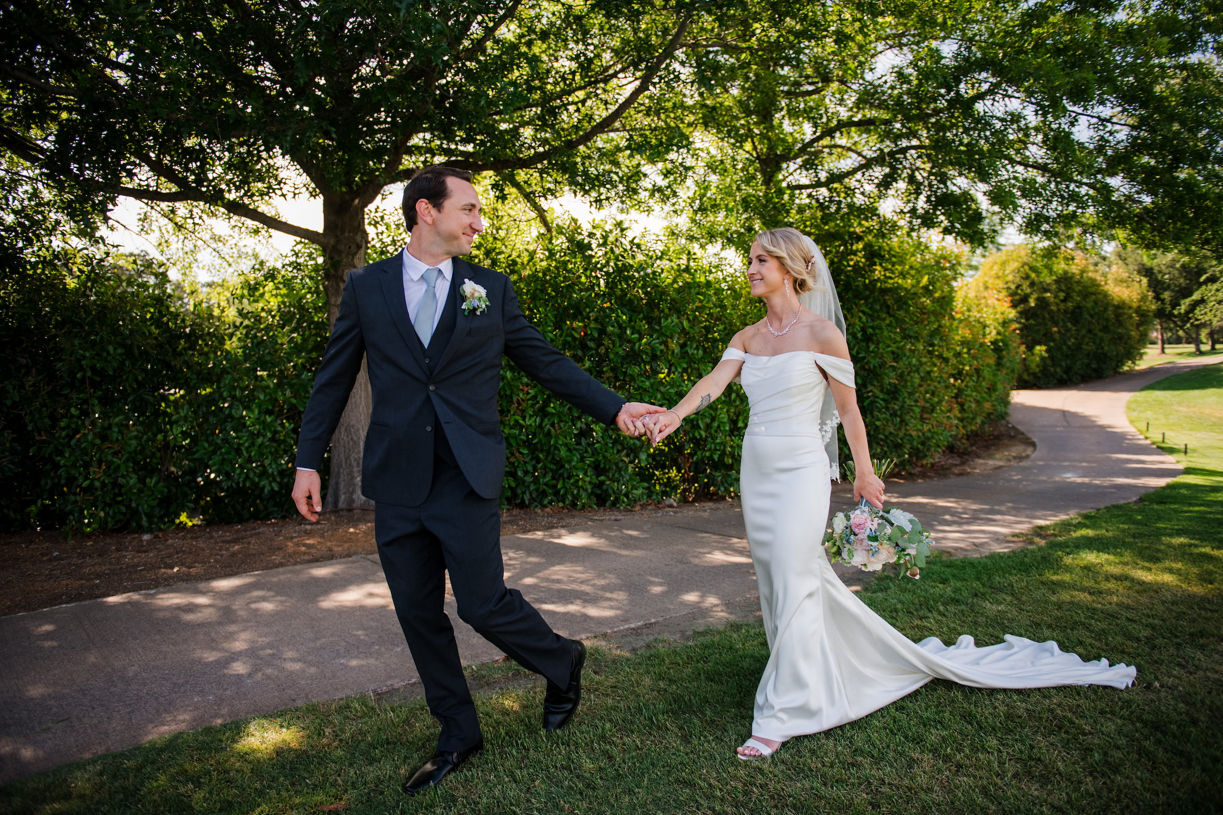 bride and groom holding hands and walking together