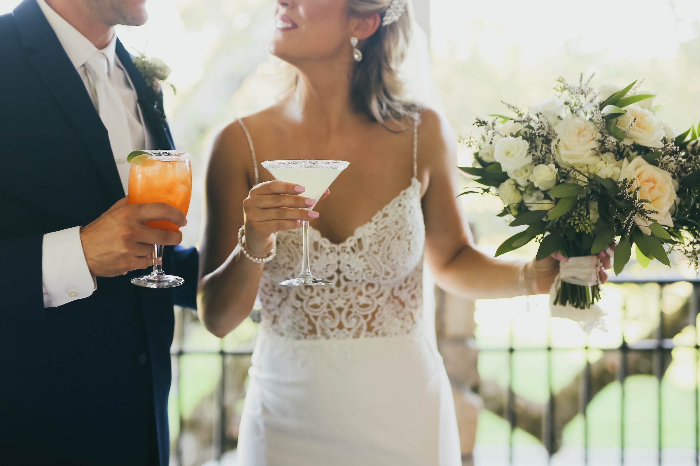 bride and groom holding their signature drinks at a wedding