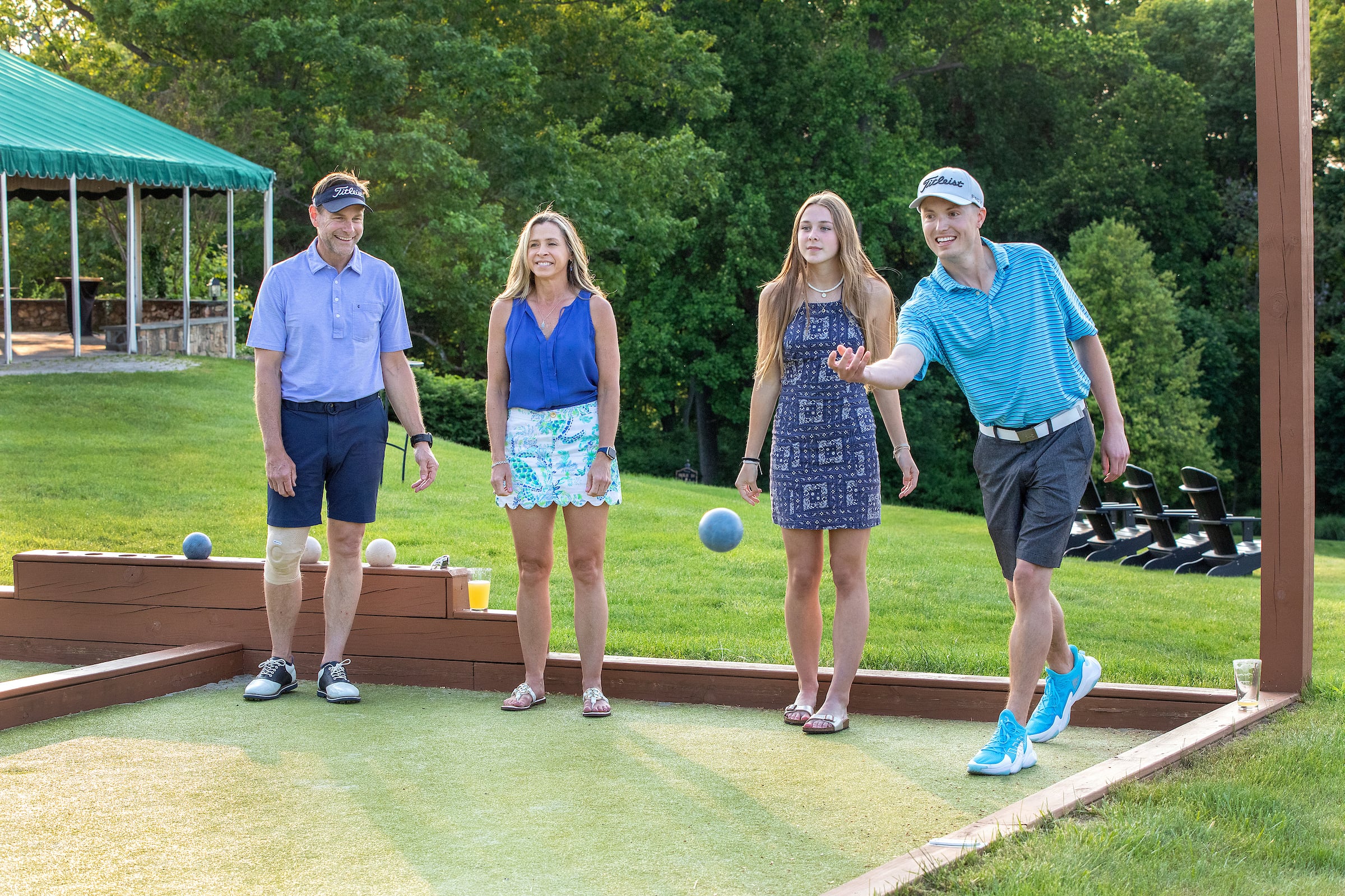 Four people playing bocce ball.