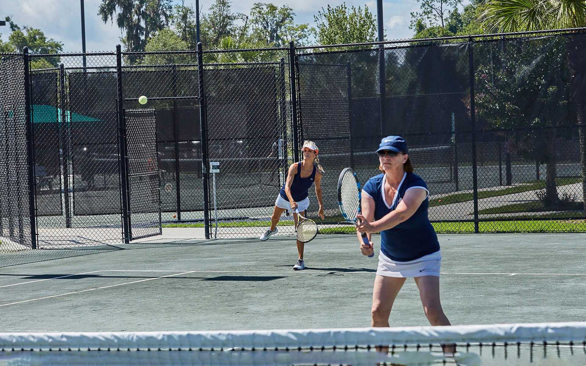 2 ladies playing tennis doubles together