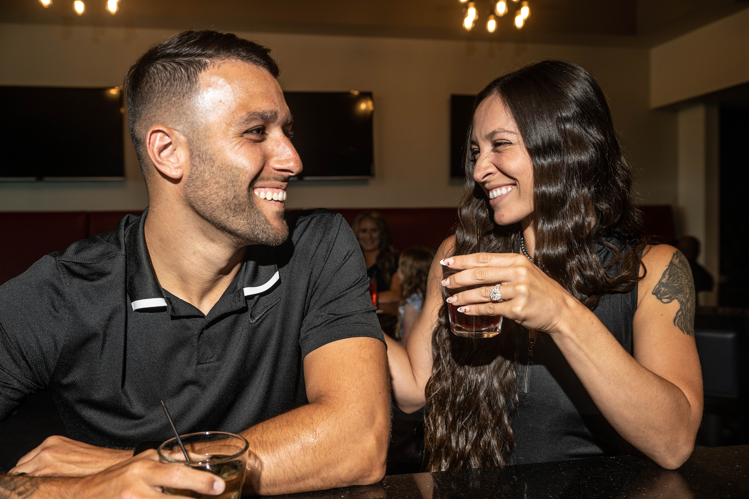 Couple enjoying drinks smiling