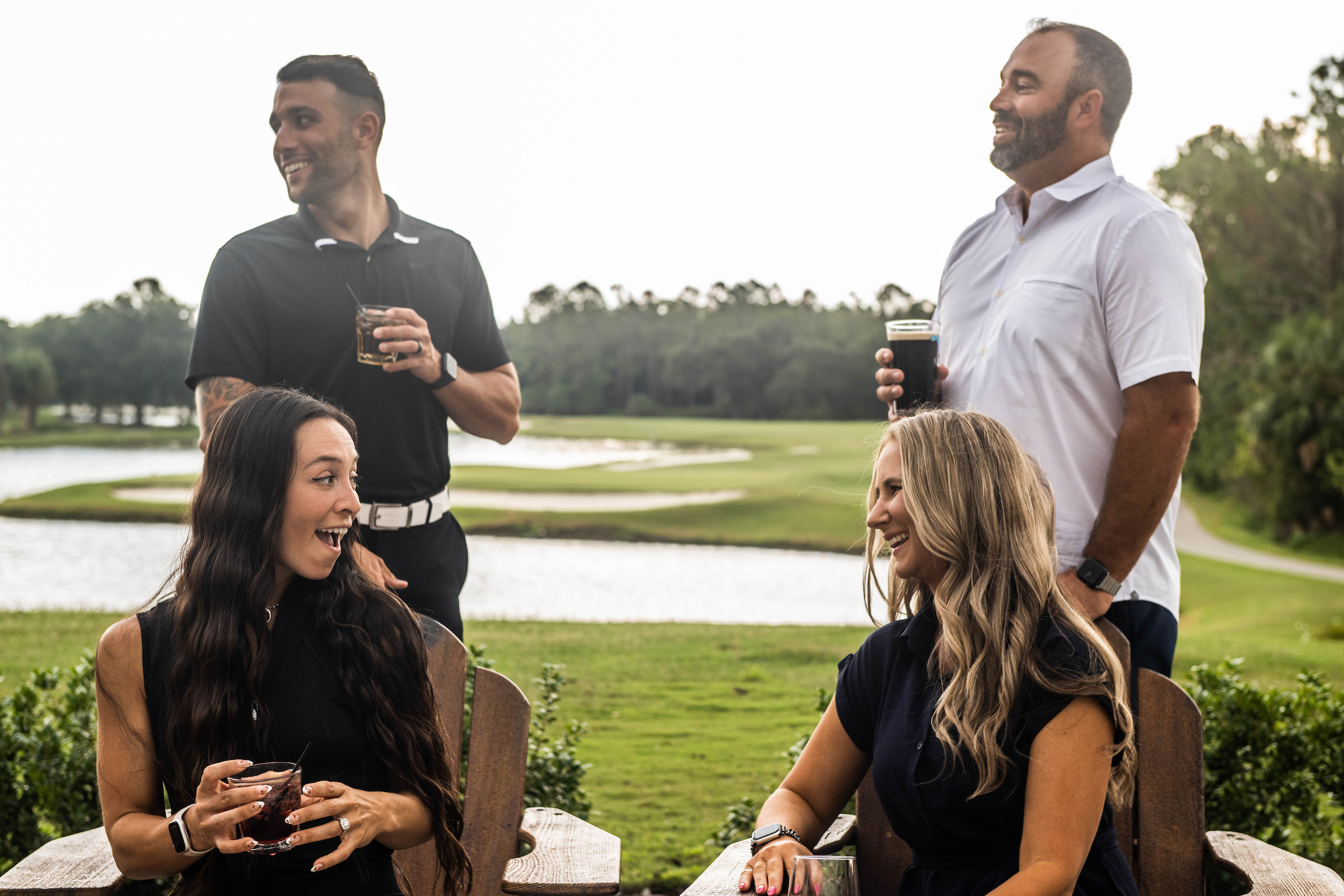 two couples enjoying drinks outside