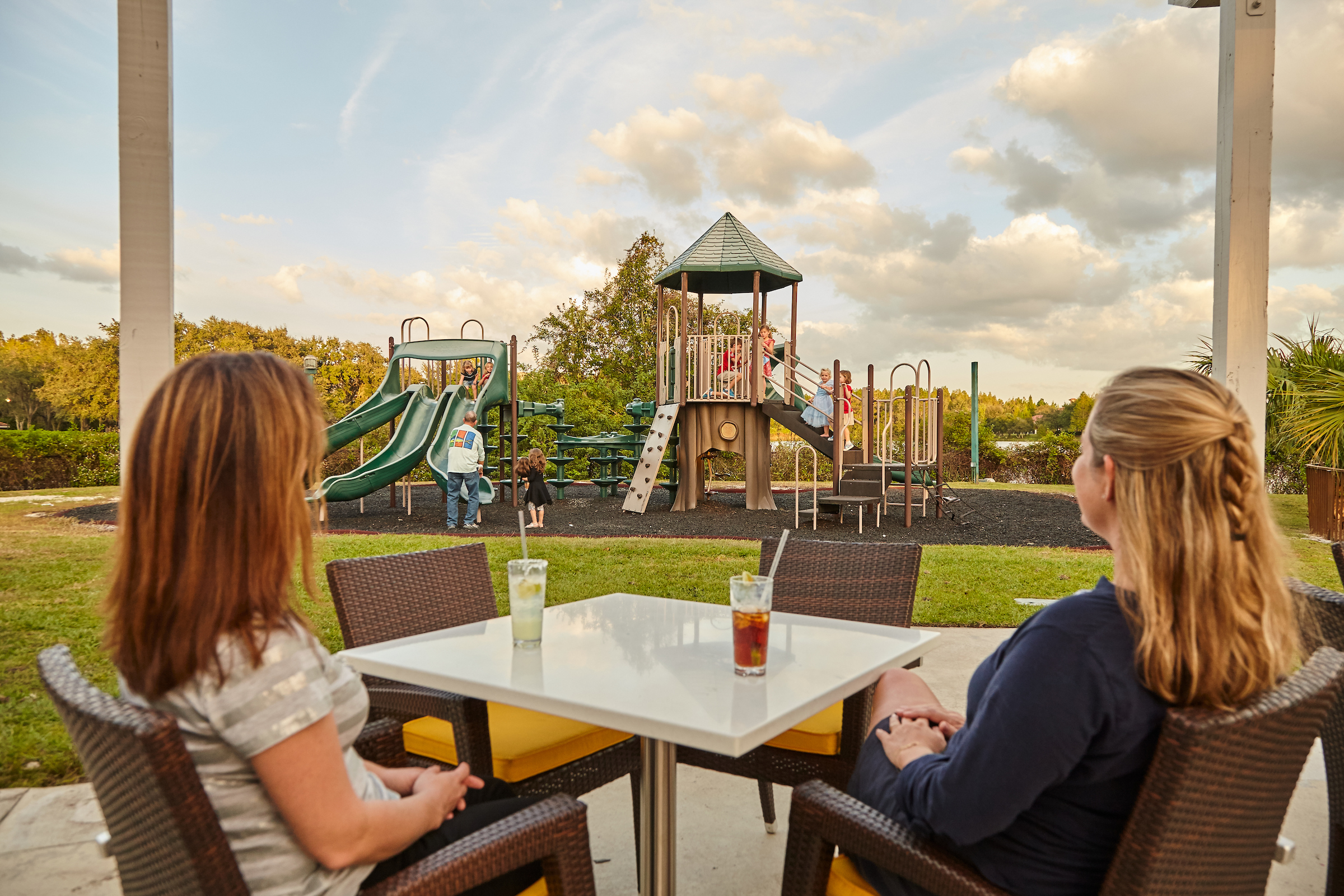 Two mothers watching their children on a playground