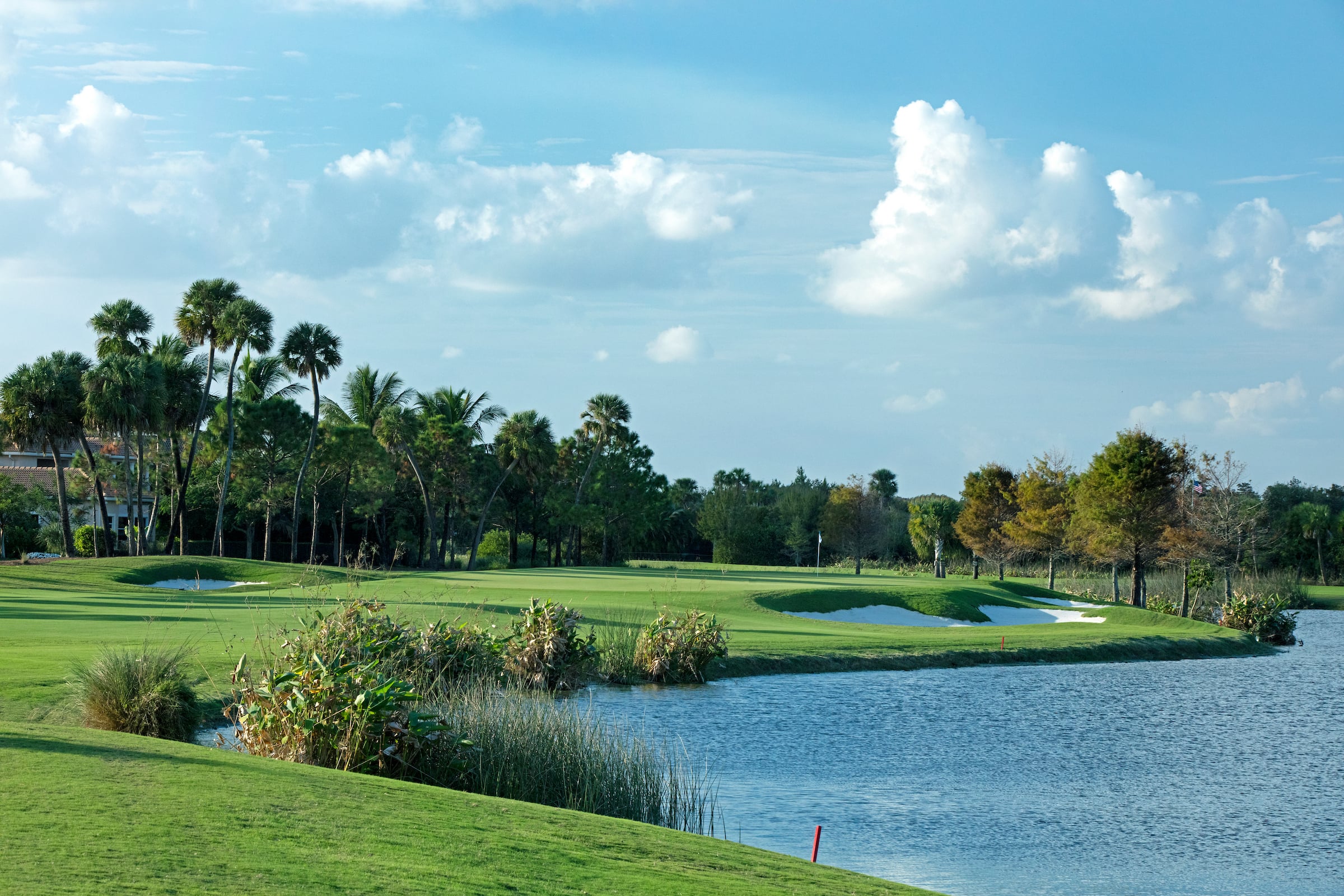 view of a golf course with a lake