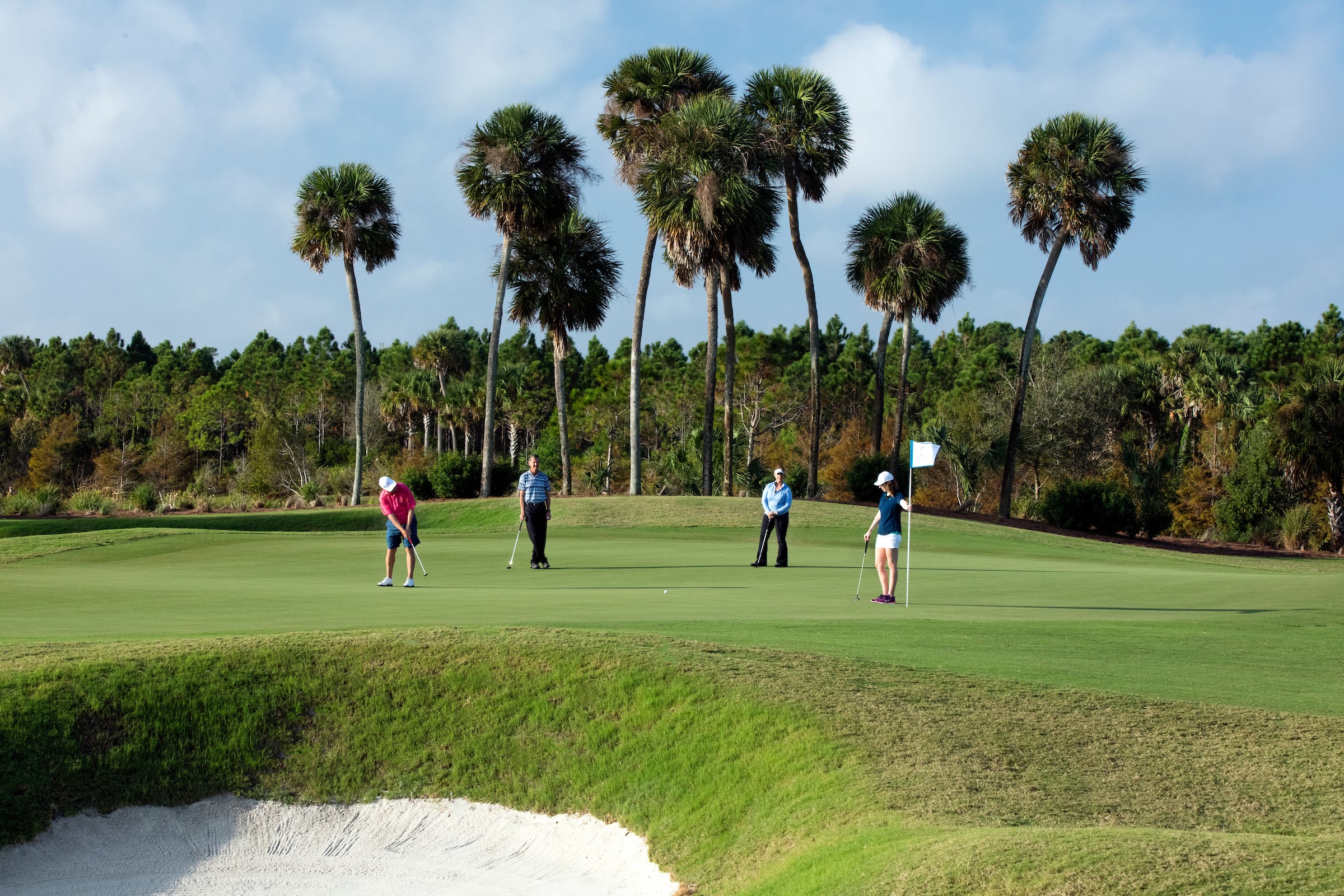 4 people on the golf course