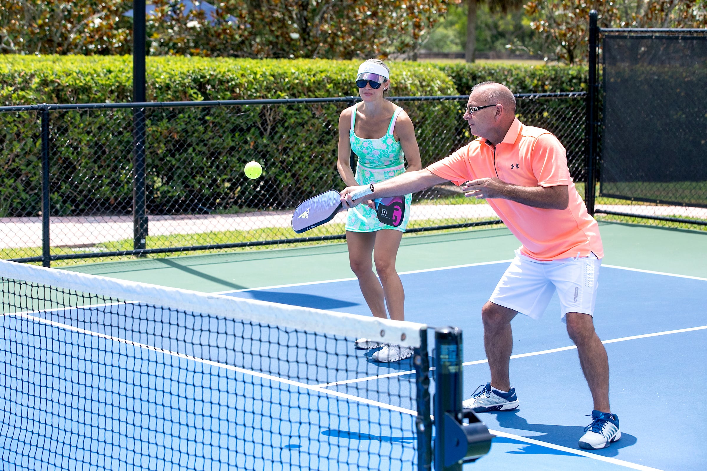 2 adults playing pickleball