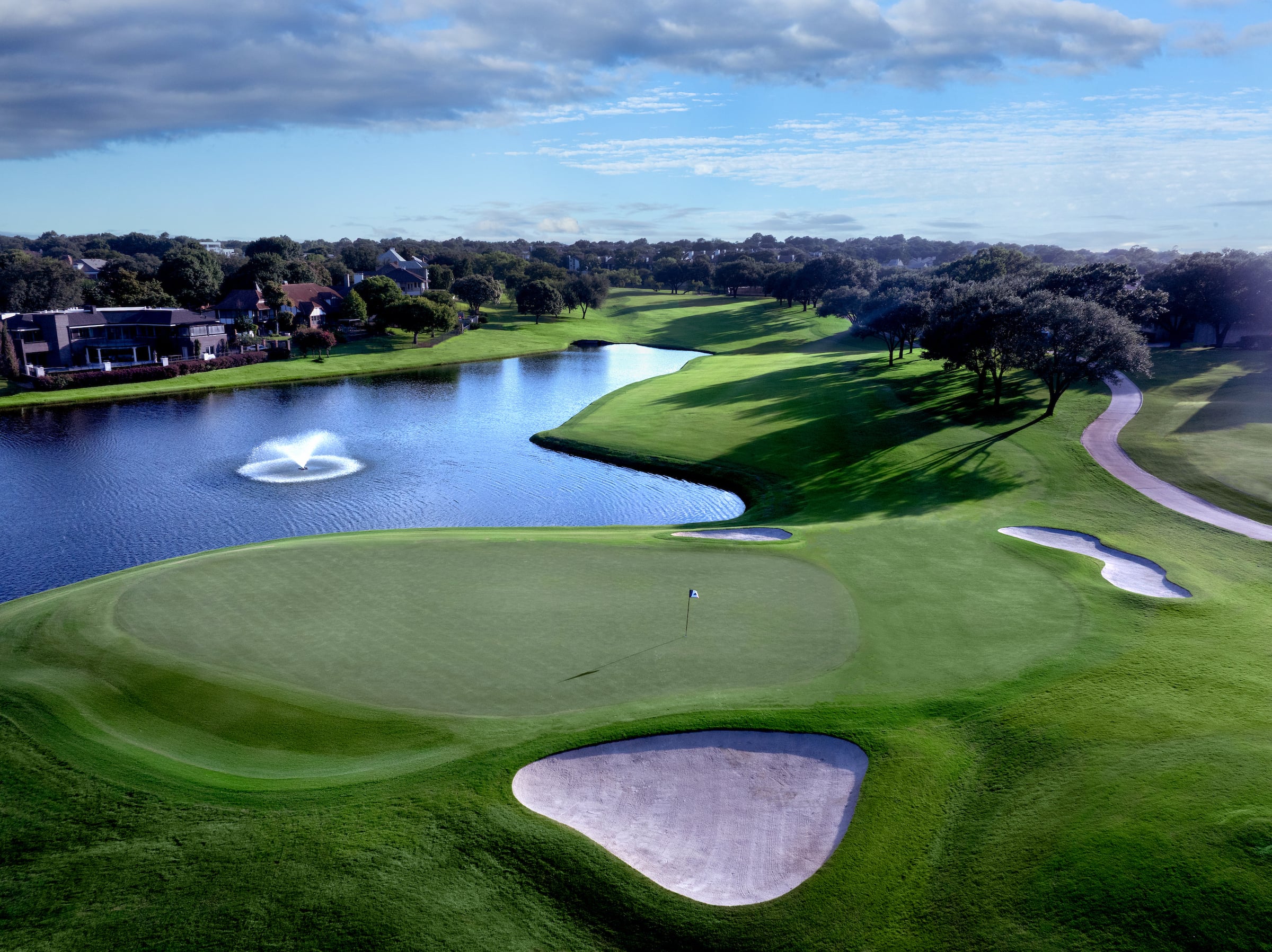 golf course view with a lake