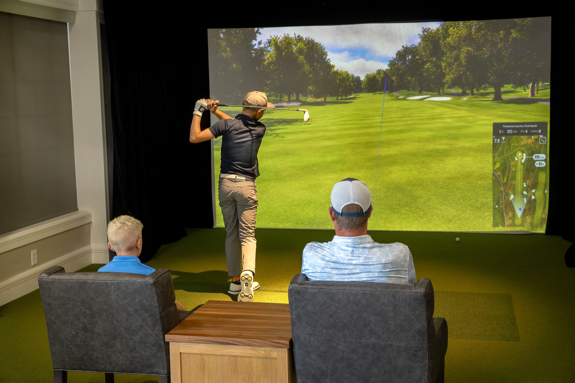 Man playing on golf simulator