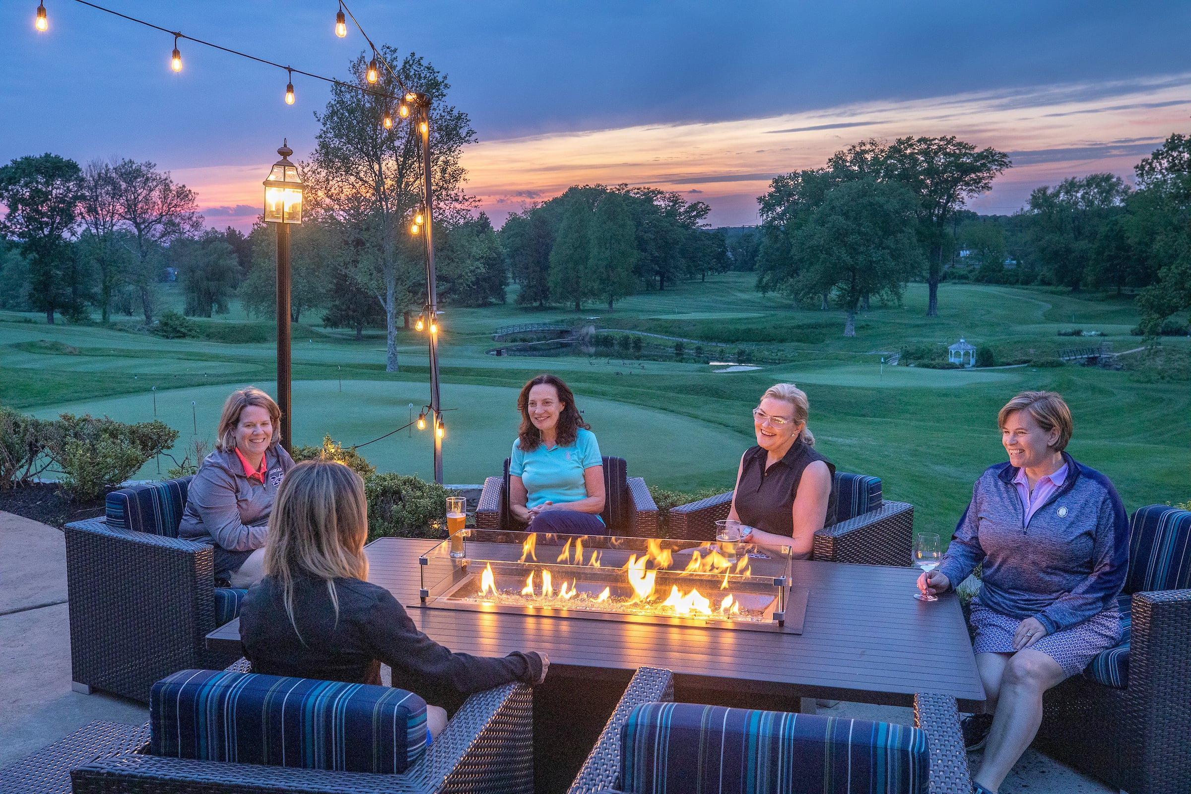 Women relaxing on a patio at dusk