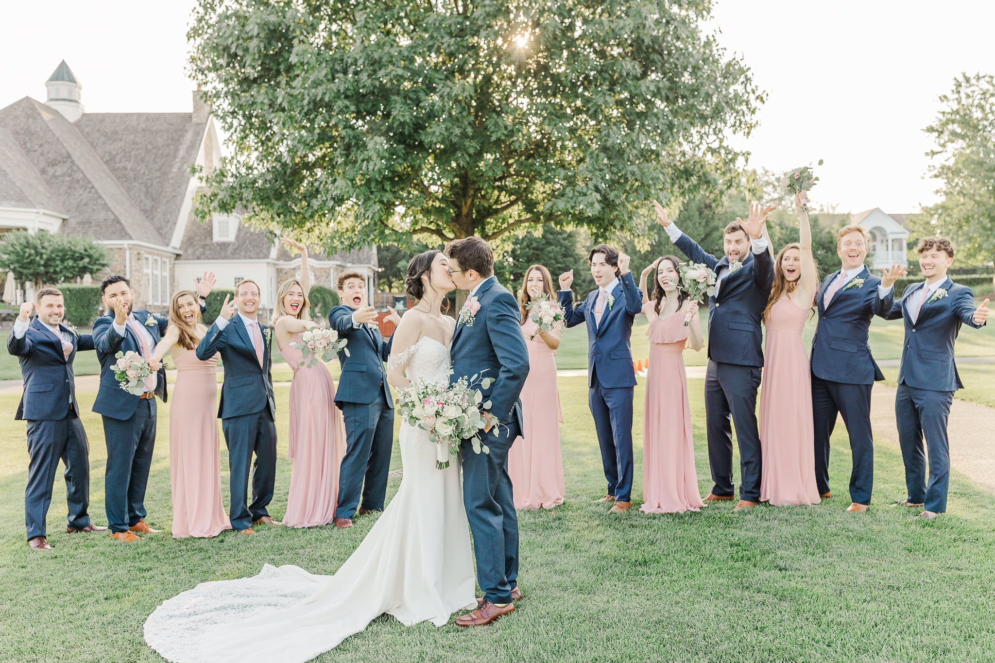 bride and groom kissing on wedding day while everyone watches