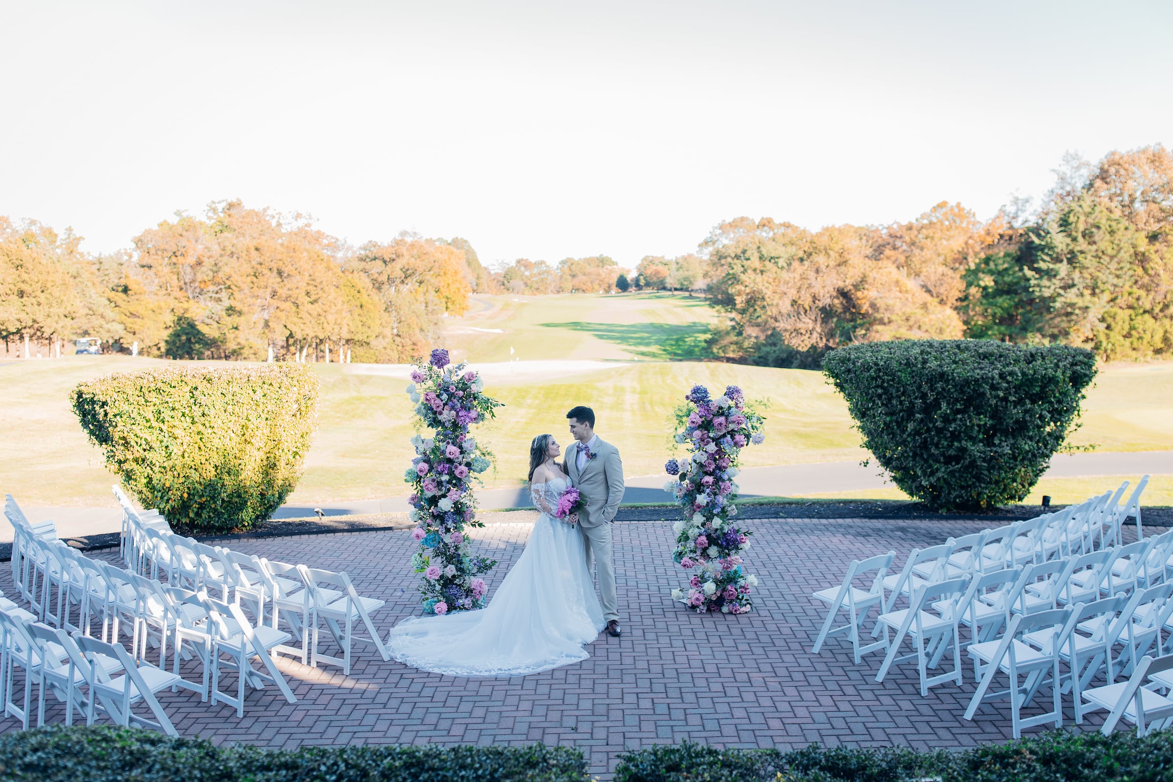 bride and groom standing outside hugging