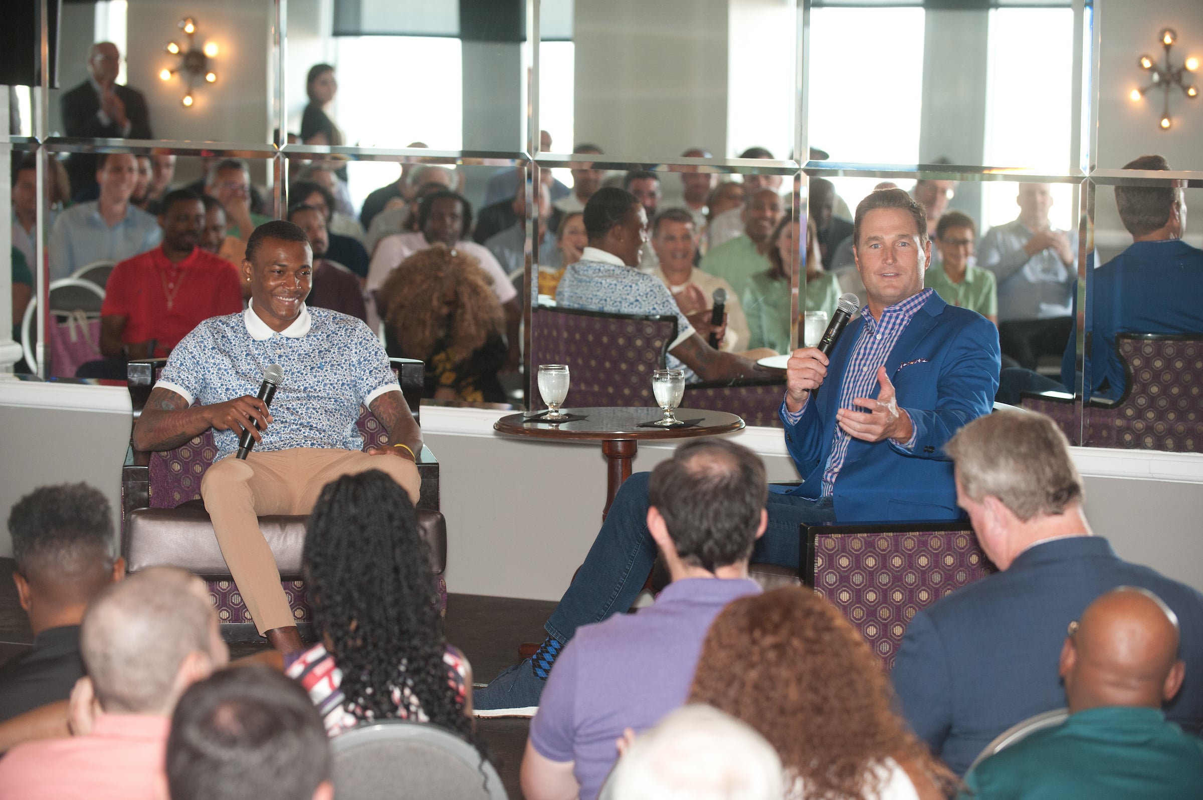 Speaker Series at Pyramid Club - Two men seated on stage speaking
