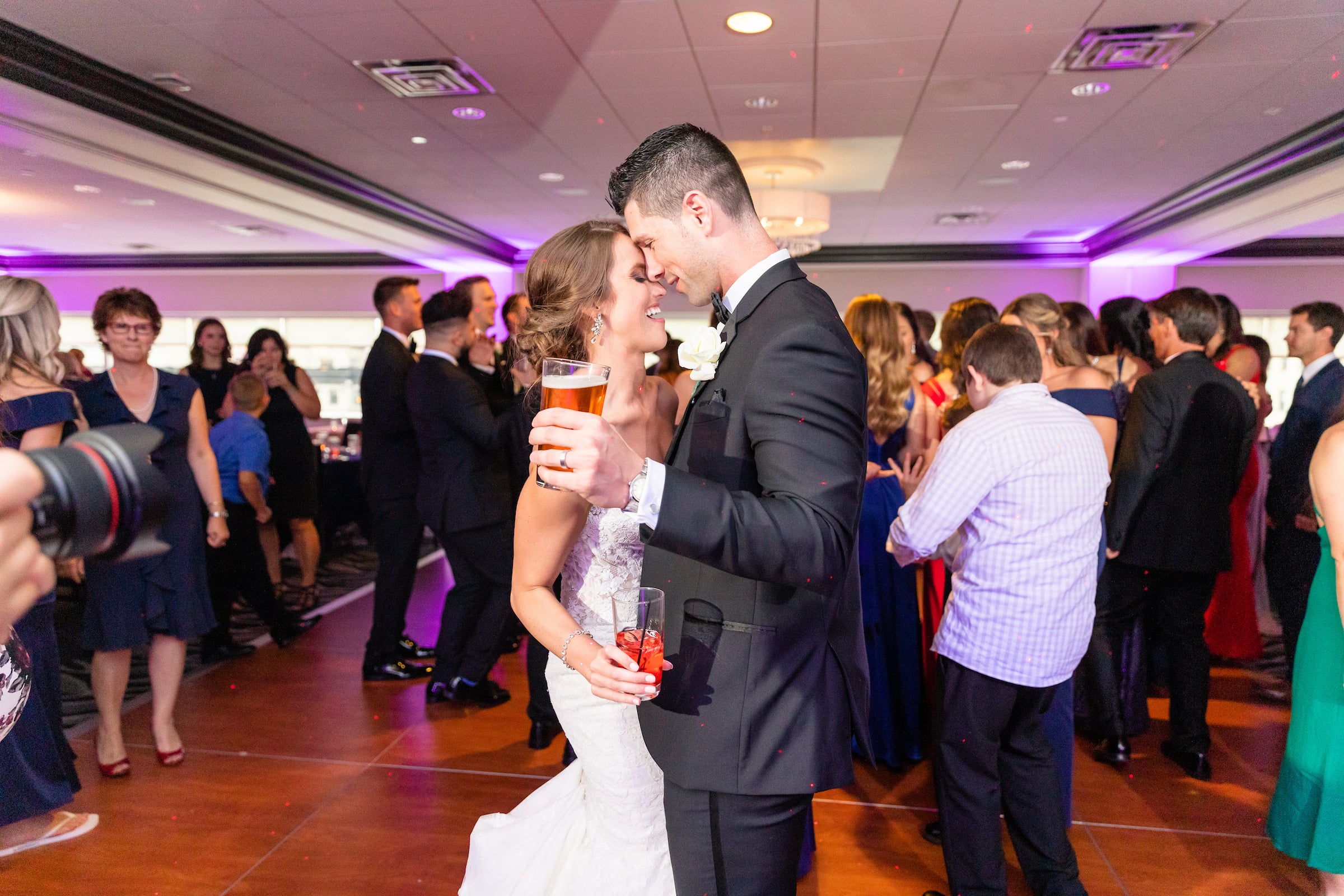 Bride & Groom dancing at their reception while holding drinks